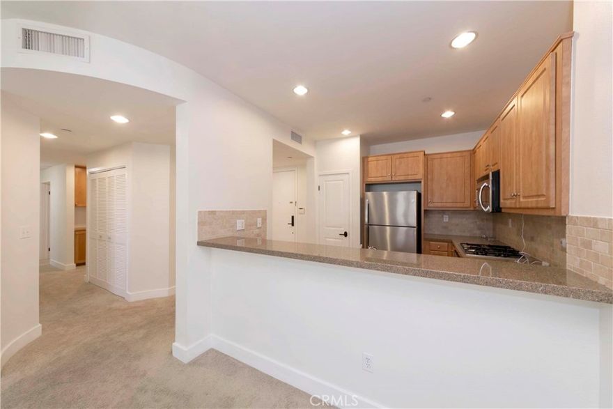 Beautiful Newer Construction in a Desirable Senior Community

This well-maintained top floor unit offers a spacious and functional layout with two bedrooms featuring sliding mirrored closet doors and a large living room with an adjacent dining area—perfect for both relaxing and entertaining.

The second bedroom is thoughtfully designed with custom built-in cabinetry and shelving, as well as a Murphy bed unit that maximizes space and flexibility, making it ideal for guests or a multi-purpose home office.

The kitchen is well-appointed with recessed lighting, granite countertops, and stainless steel appliances, including a refrigerator. The home features two bathrooms—one with dual sinks, a clear glass shower enclosure, and travertine finishes; the other with a bathtub, glass enclosure, and travertine tilework.

A hallway laundry closet includes side-by-side washer and dryer hookup, plus a storage rack for added convenience. Enjoy outdoor living on your private balcony, accessible from both the primary bedroom and the living room. Additional features include air conditioning, wood blinds or shutters throughout, and two-car tandem parking (spaces 31 & 32)  in the subterranean garage with elevator access.

Community amenities include a spacious central courtyard, a fitness center, and a clubhouse. Located directly across from Wilson Park, which hosts a vibrant farmers market twice a week, and within walking distance to groceries, restaurants, Del Amo Fashion Center, Starbucks, banks, and more. Beaches and major freeways are just minutes away.

Additional Note:

• This is a senior complex: at least one resident must be 55 or older, and a spouse or co-occupant must be 45 or older.