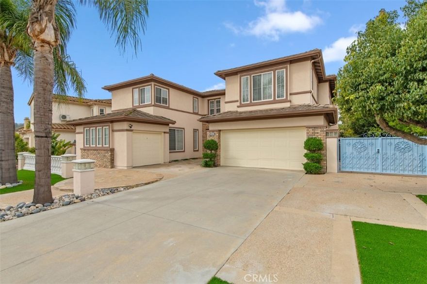 An exceptional estate within the exclusive Diamond Crest gated community, this stunning residence offers the perfect blend of luxury, elegance, and comfort. This luminous home boasts a spacious floor plan featuring 6 bedrooms, an office, and 4.5 bathrooms. The grand double entry doors open to a formal living room with soaring double-height (20+ ft) ceilings. The family room, accentuated by a cozy fireplace, seamlessly connects to the formal area—ideal for entertaining guests in style. The gourmet kitchen showcases upgraded quartz countertops, functional layout, and ample cabinetry, complementing the elegant dining room.

This architectural masterpiece perfectly combines timeless elegance with modern functionality, enhanced by solid hardwood and modern flooring throughout. The home includes multiple bedroom suites, ideal for multigenerational living. The desirable downstairs suite is filled with natural light, while the main floor office with French glass doors provides the perfect workspace. The grand master suite offers generous proportions and a luxurious retreat with an oval bathtub, separate shower, and dual walk-in closets.

Additional highlights include a three-car garage and a spacious private backyard, perfect for outdoor entertaining and relaxation with friends and family. Conveniently located near the 57 and 60 freeways, shopping, and fine dining, this home is situated within the award-winning Walnut Valley Unified School District and within walking distance to South Pointe Middle and Diamond Bar High School.