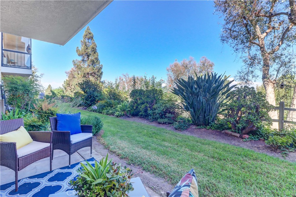 Wonderful location + view! 2BD/2BA first floor, east facing "Sierra" condo - enjoy the sunrise and mountain views from this elevated blufftop location. Great location between Clubhouses 5 and 6 - enjoy pools, small gym, game rooms, billiards and the many social activities that happen at Clubhouse 5. Walk right in and notice the vinyl plank floors and upgraded baseboards throughout leading to the spacious living/dining area with a vintage wet bar and great view. Dual pane windows/sliders (most with plantation shutters) frame the beautiful outlook and smooth ceilings give a modern feel. Kitchen features granite counters, stainless sink and microwave. Bedrooms are on the west facing side to receive the afternoon sun with good sized closets. Guest bathroom houses tub/shower combo and Corian-topped vanity while the primary bath boasts long, matching dual sink vanity area and walk-in shower behind the privacy door. Close to community laundry area and carport. Clubhouse 5 features a lap swimming pool with a gorgeous view and aquatic classes, hot pool, small drop-in fitness center, fitness studio and game room. Events are held at the large main lounge with stage and dance floor. Clubhouse 6 has a smaller pool open during the summertime and hosts many private parties and groups. Laguna Woods Village residents enjoy a 27-hole championship golf course, a 9-hole executive par 3 course, pickleball and tennis courts, lawn bowling, gyms, clubhouses, swimming pools, horse stables, gardening centers, artist studios, computer workrooms and classes + over 200 clubs and organizations.