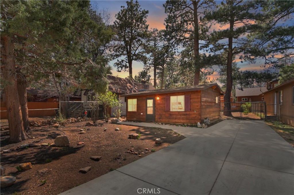 Discover this cozy and well-maintained 1-bedroom, 1-bathroom cabin close to the National Forest offering the perfect escape to the mountains. With 480 sq ft of thoughtfully designed living space on a spacious 5,000 sq ft double lot, this charming property blends rustic character with modern updates—making it ideal as a first home, vacation retreat, or income-generating rental. Step inside and enjoy the warmth of knotty tongue-and-groove natural wood walls and ceilings, and a brick fireplace ideal for curling up after a day of outdoor adventures. The open floor plan and new vinyl plank flooring create a clean, airy feel, complemented by fresh interior and exterior paint/stain that show off the home's pride of ownership. Outside, enjoy the serenity of a fully fenced, level backyard, complete with a private back deck and a custom-built wood shed. There's ample space for RV parking and boat storage on the newer concrete driveway, making this home as functional as it is charming. Located just steps from the National Forest, and within walking distance to local schools, a public park, fire station, and neighborhood market, this home offers both convenience and seclusion. Don’t miss this opportunity to own a slice of Big Bear paradise. Schedule your showing today!