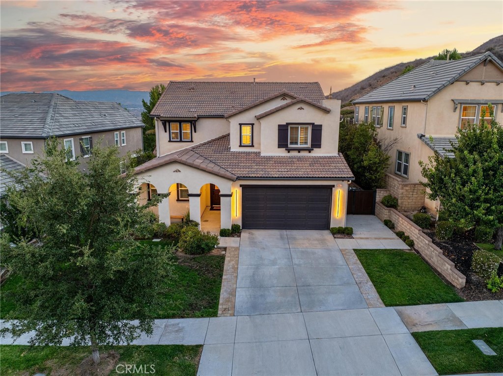 Valencia's newer gated community "West Hills" is home to this very special 5 bedroom view home on a cul-de-sac! This highly upgraded home features wide plank wood floors, fresh paint and an amazing kitchen with stone counters and updated cabinets. All new LED lighting in the last year, custom built-ins and speakers too. So many unique special features to appreciate throughout; in addition to the bedroom and office downstairs there is a custom walk-in safe. Security cameras with full perimeter coverage, built-in ethernet and POE throughout. Truly a move-in condition home in light, neutral colors. The floorplan is also incredibly functional with a bedroom downstairs offering private access to the side yard plus a second room commonly enjoyed as an office/flex space. 4 more bedrooms up, two of which have private attached baths. The 3 full bathrooms upstairs have all been updated as well and have the nice finishes everyone asks for. Custom closet in the primary bedroom. Private yard with views of the valley with no rear neighbors. The 3-car tandem garage is spacious, and the gated side yard is extra wide for toys or vehicles. Solar is OWNED. West Hills is known for the best of Valencia’s traditional community amenities; clubhouse, 3 pools, walking trails and the amazing West Creek Academy. This home is not only model perfect but also located on one of the rare cul-de-sacs in this gated community. Come home to Valencia!