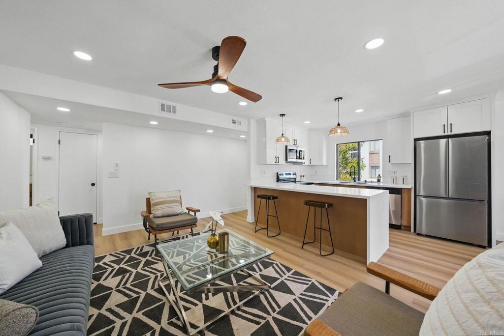 Welcome to 1915 Via Las Palmas Unit 32A – a beautifully updated 2 bed, 2 bath condo nestled in a well-maintained, VA-approved community in National City. This open-concept home has been thoughtfully remodeled from top to bottom, featuring a stunning kitchen with oak shaker-style cabinets, sleek quartz countertops, waterfall peninsula island, and modern fixtures throughout. Relax in the spacious living room with a cozy fireplace tiled floor-to-ceiling and new vinyl plank flooring that flows seamlessly throughout the home. Both bathrooms have been tastefully updated, and the primary suite offers dual vanities with ample countertop space, generous storage, and a large closet for all your essentials. Off of the living room is a good sized balcony with a storage room that contains the washer and dryer and hot water heater. Forced air central heating, and assigned parking space #42 with plenty of guest parking throughout the community. As a major bonus, this unit includes a detached storage room (#32A)—perfect for bikes, seasonal decor, or beach gear. The community also features a sparkling pool and spa, and offers quick freeway access for commuters. This is a rare opportunity to own a move-in-ready home with exceptional features and community amenities. Don't wait—this one won’t last long!