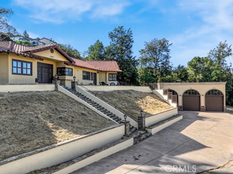 A rare and remarkable opportunity in West Hills—two fully independent homes on an expansive .79-acre lot, perfect for multi-generational living, rental income, or running a small business from home. The main residence features 5 bedrooms and 4 bathrooms, including a private 2-bedroom in-law suite with a kitchenette and separate entrance. Bathed in natural light with sweeping canyon and mountain views, this home offers open living spaces, spa-like bathrooms, and effortless indoor-outdoor flow. The detached upper home includes 3 bedrooms, 2 baths, a full kitchen, private patio, and separate driveway—ideal for extended family, guest quarters, or a business/studio setup. Enjoy a resort-style pool, spa, BBQ area, lush gardens, and a 3-car garage plus parking for 10+ vehicles. With nearly .8 acres of land, there’s room to add a sport court, orchard, or your own private retreat. This is more than a home—it’s a legacy property with unlimited potential.