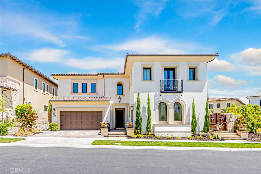 Welcome to Altair, a prestigious 24-hour guard-gated community. This mansion boasts the coveted Callisto floor plan with 5 bedrooms, 5.5 bathrooms, and two garages. It features a Master Resort Style retreat, a spacious loft, a fully-equipped kitchen with an oversized island and prep kitchen, a guest suite, and a convenient office.
The grand foyer with dual spiral staircases welcomes you. The master suite is a sanctuary with a spacious retreat, walk-in closet, double vanities, glass door shower, and soaking tub. Each secondary bedroom has its ensuite.
Laminate wood flooring extends throughout, even in closets and stairways. Glass stacking doors create seamless indoor/outdoor living. The outdoor space includes a California room, a water fountain, and lush vegetation.
A private entertainer's cave sets this property apart. Altair offers resort-style amenities, including a Private Clubhouse, pools, Jacuzzi, and tennis courts. Award-winning Irvine Unified Schools, Great Park, Irvine Spectrum, and Woodbury Shopping Center are within walking distance. This is luxury and convenience in one.