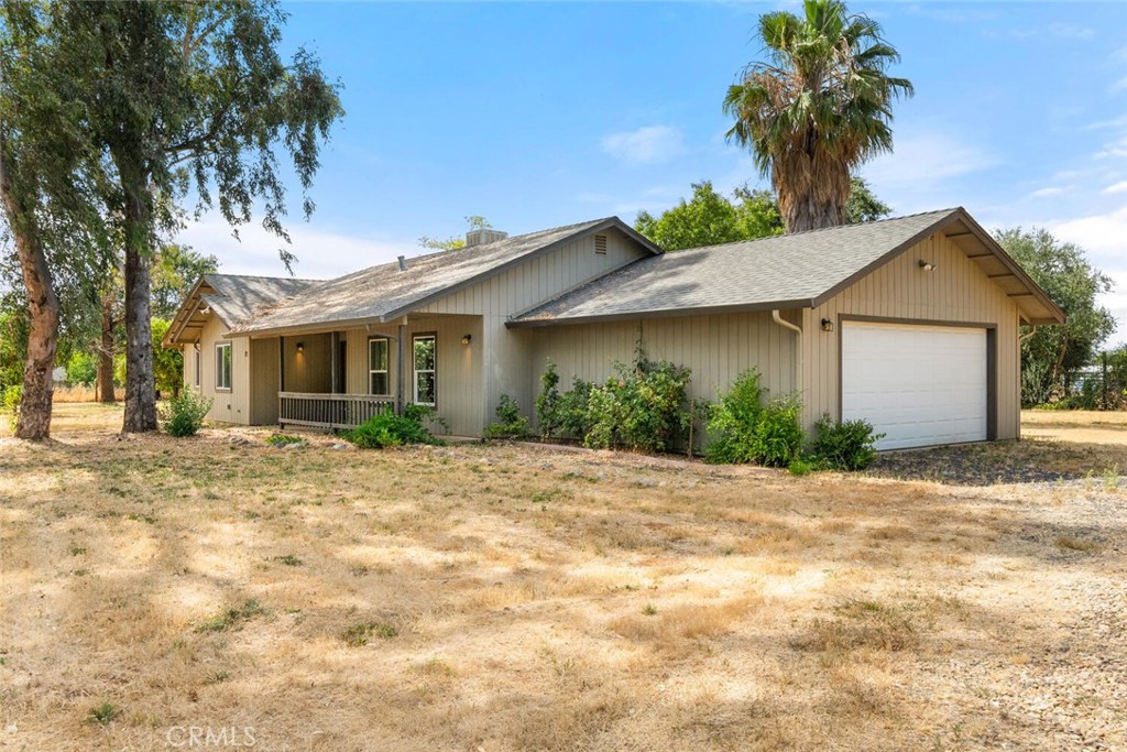 Welcome to 71 School Street in Oroville a charming single-story home nestled on just over an acre of flat, usable land. This well-maintained property features 3 spacious bedrooms, 2 bathrooms, and an open-concept living area with vaulted ceilings and abundant natural light. The updated kitchen boasts granite countertops, stainless steel appliances, and a range hood, perfect for cooking and entertaining. Enjoy the comfort of an indoor laundry, a covered front porch, and an oversized 2-car garage with ample parking for RVs, boats, and toys. The lot is dotted with mature fruit and nut trees, offering a peaceful, rural lifestyle just minutes from town amenities.