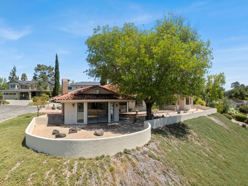Sprawling Single Story Spanish Ranch Retreat in the Heart of Los Altos - Step into timeless California charm with this expansive single-story Spanish ranch style home, set on a generous hill top lot with jaw dropping views, the property features a large, private stucco-fenced patio area with plenty of space to add a pool or create your dream outdoor oasis. Inside, the home boasts great bones and vintage character, ready for your vision. Whether you're looking to move in, remodel, or expand, this is a rare opportunity to own a spacious, sun-drenched Los Altos classic in an unbeatable location. Ideally situated just 0.6 miles from the Rancho Shopping Center home to Andronico's, Starbucks, Redwood Grill, Main Street Bagels, Green Bakery, Pho Banh Mi, salon services, tutoring, and more. Ask about the secret safe walking path that avoids Magdalena. I walked there in only 11 minutes, rode the bike there in 3 minutes. With stunning hillside views from nearly every room, this home blends the tranquility of country living with unbeatable convenience. You're also just a 0.6-mile walk to the Los Altos Golf and Country Club, and minutes from Highway 280 for effortless commuting.