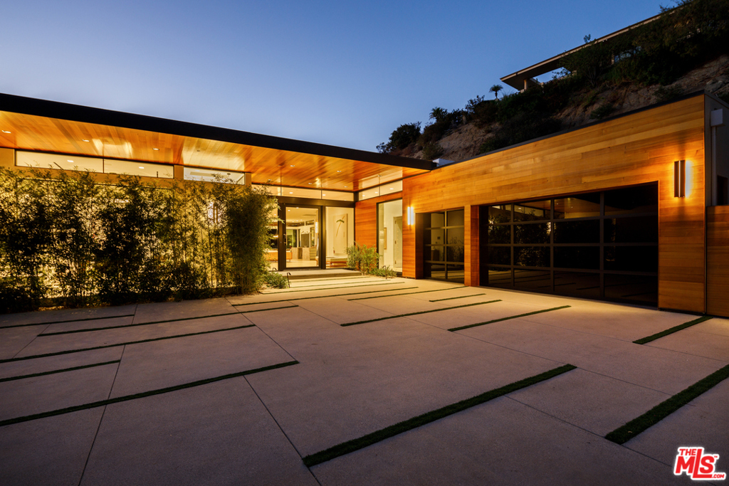 Privately nestled in the iconic Trousdale Estate awaits this one-of-a-kind, newly built contemporary masterpiece w/explosive vistas, custom finishes & highly curated design. Moments from the best of BH, this secluded oasis sits on a 32,871SF lot & welcomes you w/meticulous landscaping & gate opening to an oversized motorcourt. Open floorplan w/grand volume & floor-to-ceiling disappearing walls of glass highlighting views. Gourmet kitchen w/islands, Miele appliances, espresso machine & pantry. Master wing feels like a 5-star resort w/Fleetwood doors to yard & views. En suite bath w/tub, Calacatta shower, dual vanities & gorgeous boutique-worthy closets w/built-ins & lounges. Amenities: opulent custom wood/marble bar, theater, skylights, Buster&Punch hardware & so much more! Spacious outdoor living for al fresco dining/lounging w/limestone patios, heaters, BBQ & infinity pool blending into the horizon. A sleek yet warm modern estate, this stunning home will steal your heart!