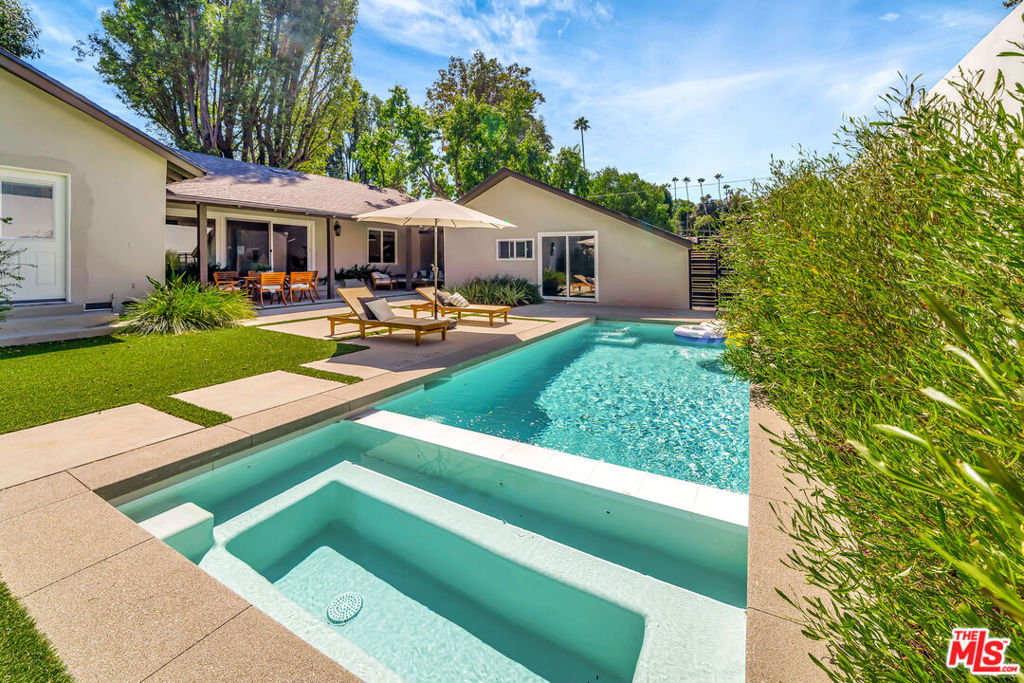 Stunning 4 Bed / 4.5 Bath Contemporary Home with Pool! Prime Woodland Hills/Tarzana location. Beautifully remodeled and move-in ready, this spacious 4-bedroom, 4.5-bathroom home is located 25 minutes from the beach, minutes from amazing parks, trails for hiking, dogs, and bikes next to great dining, shopping, and coffee spots. Key Features: a luxurious primary suite with king bed and en-suite bath. Modern kitchen with stainless steel appliances, large center island, and tons of counter space. Spacious living area perfect for relaxing or entertaining with plush seating and large flat-screen TV. Private 10,000 sq. ft. backyard features a sleek pool, hot tub, and lush landscaping. Detached oversized 2-car garage ideal for parking or extra storage. All appliances included including washer and dryer. This home is perfect for anyone seeking comfort, space, and a great location in a quiet, upscale neighborhood. Rental Terms: Unfurnished rental 12-month minimum lease. Owner pays for pool and garden maintenance. Furnished option available for an additional monthly fee.