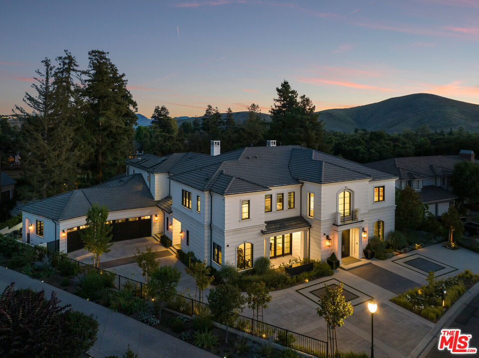 Nestled within the prestigious gated community of Oak Place and overlooking the exclusive North Ranch Golf Course, this meticulously crafted estate exemplifies luxury living. Spanning nearly 10,000 square feet on .59 acres of beautifully landscaped grounds, this 7-bedroom, 10-bathroom residence offers an unparalleled living experience. The home features first-class amenities, including a primary suite with breathtaking golf course views, an expansive walk-in closet, and a sun-drenched, resort-style bathroom. Key highlights include a spacious formal dining room, a show kitchen, a private chef's kitchen, a butler's pantry, a billiard and poker room, a full bar, a wet bar, a state-of-the-art movie theater, and a fully integrated Crestron Home Control System. The seamless indoor-outdoor flow is enhanced by custom Fleetwood doors that lead to a stunning backyard, complete with a golf simulator, pool, spa, pool house, multiple bars, and a fire pit. Designed for ultimate entertainment, this property leaves nothing to be desired. Conveniently located near award-winning public and private schools, it provides access to some of the finest educational opportunities available. Welcome to the pinnacle of North Ranch living.