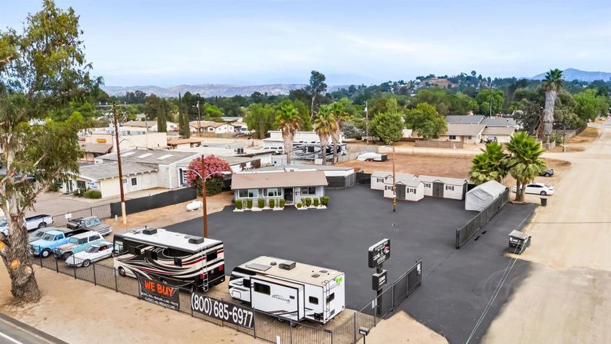 Welcome to 2366 Main Street in Ramona, the premier gateway property into town and one of the best commercial-residential opportunities available. Situated on 0.72 acres with prime visibility on Main Street, this versatile live/work property spans approximately 1,500 square feet with a flexible layout and zoning that allows for residential, commercial, and automotive use.  The property has been home to a successful RV and auto sales business generating an average of roughly $1,000,000 in annual revenue over the past two years, making it a proven, income-producing location with exceptional exposure and traffic.  Inside, the residence features three bedrooms and two and a half bathrooms, including two full bedroom suites with beautifully remodeled baths. The kitchen has been completely updated with a large center island, premium Cosmo appliances, soft-close cabinetry, and built-out closets for added functionality. Additional interior upgrades include all-new tiled flooring, recessed lighting, a water softener, and warm neutral tones throughout, creating a clean, modern feel.  The attached office at the front of the building provides a large, professional workspace with its own half bath and upgraded ceiling fan, ideal for running a business while maintaining privacy at home.  Outside, the property continues to impress with extensive improvements. The backyard has been redesigned with a covered, fully tiled patio perfect for entertaining or outdoor work meetings. The front car lot is fully fenced with wrought iron gates for added security, and the asphalt has been freshly repaved, giving the property a clean, professional appearance. Two utility sheds offer additional storage, and the back portion of the lot remains open dirt—ideal for expansion, additional parking, or redevelopment.  With its mixed-use zoning, high visibility, and proven business income, 2366 Main Street offers endless possibilities for investors, owner-operators, and entrepreneurs alike. Whether you choose to live, work, or lease it out, this is a rare opportunity to own one of Ramona’s most versatile and profitable properties.