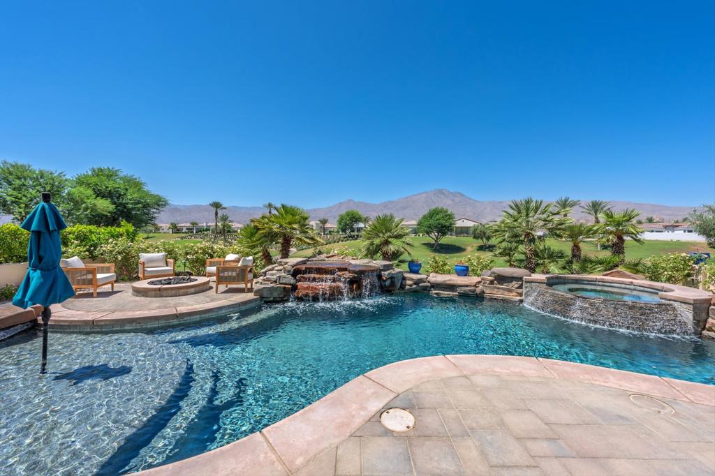 Ideally positioned on the 10th fairway of the Rees Jones-designed golf course, this beautifully appointed south-facing residence offers the perfect blend of luxury, comfort, and timeless design. Enter through a spacious private courtyard, where the gentle sound of a fountain sets a serene tone, and discover a detached two-bedroom casita complete with a cozy fireplace and kitchenette, perfect for hosting guests in style. Inside the main residence, the expansive great room is framed by soaring 12′ glass doors that blur the line between indoors and out, drawing your eye to breathtaking views of the Santa Rosa and Coral Mountains. The open concept layout flows effortlessly into the gourmet kitchen, featuring elegant waterfall countertops and top-tier appliances that make cooking a delight. The primary suite serves as a peaceful haven, seamlessly connecting to a spa-like bath and offering direct access to the backyard. Outside, you will find a private escape with a custom pool, built-in BBQ, and an inviting firepit that sets the stage for year-round entertaining and relaxation. Additional upgrades include an owned solar system, as well as a new HVAC system and a tankless water heater, both installed in May 2025. Come live the life you've always imagined!