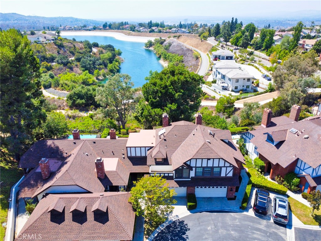 Brand-New Renovation Inside and Out – Stunning Views Await! Welcome to 950 Rim Crest, a beautifully renovated two-level condo tucked into the serene, rolling hills of Anaheim’s sought-after Rim Crest Villas. Boasting panoramic VIEW-VIEW-VIEWS, this 2-bedroom, 2.5-bathroom gem offers a perfect blend of modern luxury and peaceful, suburban living—just minutes from everything you need. From the moment you enter on the garage level, you’ll notice the thoughtful layout designed for both comfort and functionality. A convenient half bath sits just off the entry, while a few steps down lead you into the main living area, where soaring ceilings and abundant natural light create a warm and open atmosphere. The living room features a cozy fireplace and flows seamlessly into the dining area, both with French doors that open to a private backyard oasis—ideal for indoor-outdoor living, entertaining, or simply enjoying the tranquility of nature. The brand-new kitchen is a chef’s dream, offering sleek quartz countertops, modern cabinetry, double ovens, and ample storage—perfect for gatherings and everyday meals alike. Retreat to the luxurious master suite, complete with a second fireplace, private balcony, and a spa-inspired bathroom with sinks, soaking tub, and separate shower. The second bedroom is equally impressive, offering a walk-in closet, and its own sun-drenched balcony—a perfect spot to savor the California sunshine. Outside, the low-maintenance backyard features AstroTurf and mature trees for year-round enjoyment and shade. Just steps from your door, you’ll find direct access to the scenic 2.5-mile trail around Walnut Canyon Reservoir, with connections to the Oak Canyon Nature Center and miles of hiking and biking trails. Community Amenities: Sparkling pool & spa Cedar sauna HOA-provided exterior maintenance Prime Location: Walk to Canyon Rim Elementary School & local park Quick access to 91 & 55 Freeways, 241 Toll Road Close to Savi Ranch, Yorba Regional Park, shopping, dining & more Don’t miss this rare opportunity to own a completely updated, move-in-ready home in one of Anaheim Hills' most peaceful and scenic communities.