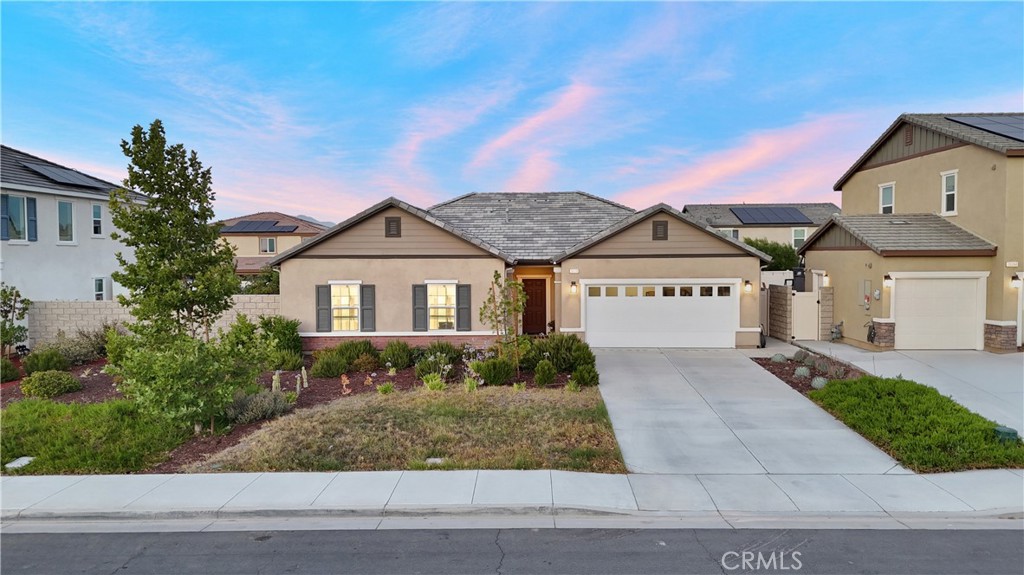 Welcome to 26038 Redoak St in Hidden Hills, one of Menifee’s most sought-after communities. This tastefully upgraded single-level home, built in 2021, offers 4 bedrooms, 2 bathrooms, and 2,326 square feet of thoughtfully designed living space on a spacious 7,405 sqft lot. From the moment you arrive, you’ll be captivated by the beautiful curb appeal, expansive driveway, and manicured front lawn. Inside, the home welcomes you with a bright, open floor plan featuring recessed lighting, abundant natural light, and newer laminate flooring throughout. The gourmet kitchen is a true centerpiece - featuring granite countertops, an oversized island, ample cabinetry, and a walk-in pantry - all flowing effortlessly into a spacious great room that’s perfect for both everyday living and entertaining. Enjoy seamless indoor-outdoor living with sliding doors that lead to a beautifully landscaped, low-maintenance backyard, complete with a covered patio, built-in BBQ and sink, irrigated raised garden beds, and a variety of mature fruit trees, including pomegranate, persimmon, fig, orange, grapefruit, and apple. The front garden also features fragrant rosemary, adding to the home's inviting atmosphere. The primary suite offers a peaceful retreat, featuring a completely remodeled bathroom with a dual-sink vanity, walk-in shower, and an extra-large linen closet - along with a spacious walk-in closet. Every detail was thoughtfully upgraded to create a spa-like atmosphere. The additional bedrooms are generously sized, and the fourth bedroom, currently used as a Pilates studio, can easily be enclosed to create a private space. Additional highlights include a separate laundry room with sink, ample storage throughout, leased solar panels (currently resulting in no electric bill), a 2-car garage, and a sprinkler system. All of this comes with a very low HOA and access to exceptional community amenities, including a park, playground, tennis court, sports court, and scenic walking trails. Don’t miss your opportunity to own this move-in ready, beautifully upgraded home in one of Menifee’s most desirable neighborhoods!