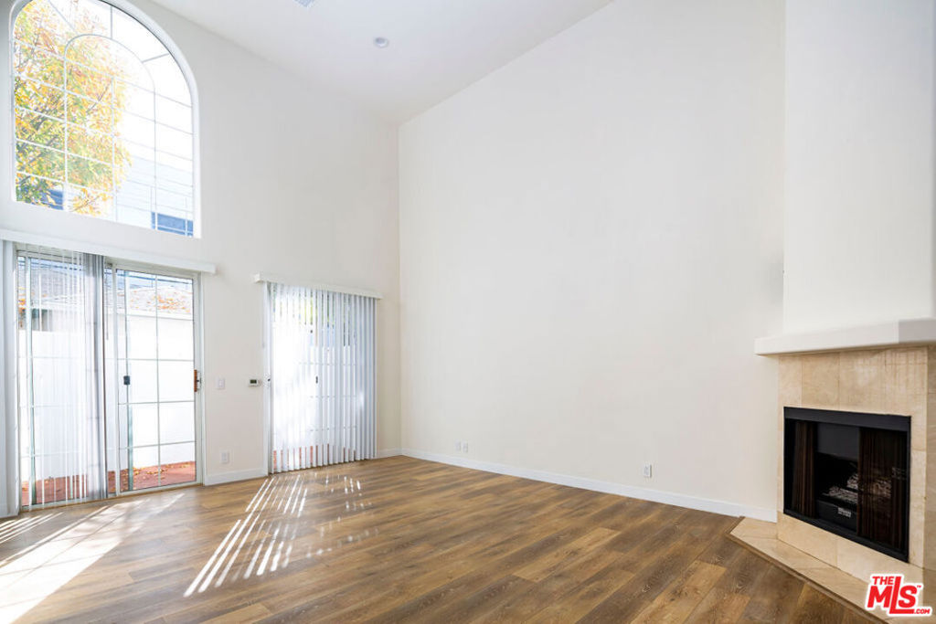 Dramatic, front-facing townhome with four private outdoor spaces in amazing location in close proximity to restaurants and upscale shopping. Upon entering, you are greeted by light flooding into living spaces and ~20 foot ceilings. Recently updated kitchen with stainless steel appliances, new quartz countertops, and backsplash. Spacious great room featuring beautiful wood flooring, fireplace, and private patio running the length of the unit. Enjoy ocean breezes through sliding doors on both sides of the great room. Head upstairs to loft, which overlooks the great room and is the ideal spot for a home office. Loft has small, adjacent room with a window that could be a second office or bonus space. Continue to two generously-sized bedrooms, both with en-suite baths and balconies. On the top level is a large private roof deck. Private 2-car garage with direct access and extra storage. Park your vehicles or make it your home gym. In-unit laundry, gated, intimate 5 unit building & Santa Monica schools. Too many other features to list!