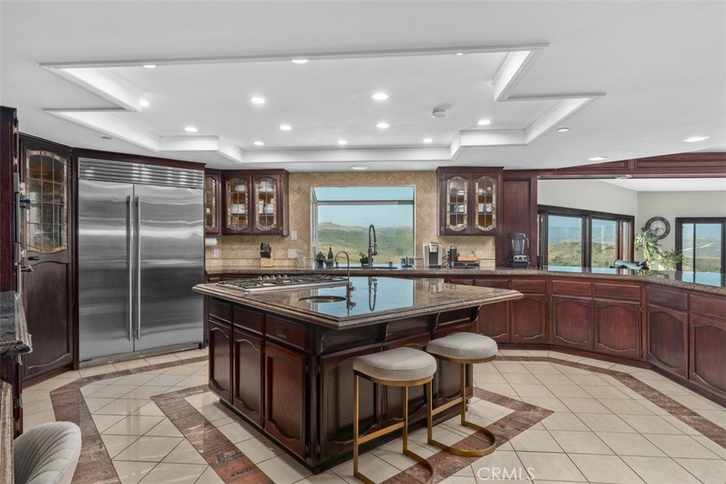 This stunning Traditional 5 bedroom and 4.5 bath home with 3 car garage has all the goodies. Brand New AC systems were just installed. This home is the ultimate in coastal living with canyon ,hills and a pee-a-boo ocean sunset ocean view. Situated on a hilltop 1.4 acre lot. Kitchen is fit for the chef with all professional grade stainless commercial appliances and large center island. Home comes fully furnished and is ready for immediate occupancy. Home has a separate downstairs bedroom ideal for older family members or kid come home. Comes with both washer and dryer. 4 of the five bedrooms are ensuite. Has oversized family room with fireplace and a bar room area also having fireplace. Home has an indoor jacuzzi tub that leads out to a deck that runs the entire length of the home. All newer restoration hardware patio furniture, heat lamps, BBQ, and fridge. Please call to see this amazing home.