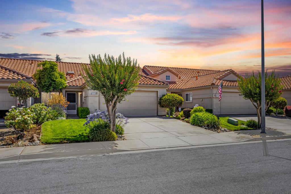 Welcome to this single-story beautifully maintained and thoughtfully upgraded 2-bedroom, 2-bathroom home, ideally located in a peaceful and friendly 55+ neighborhood. A welcoming tiled entryway flooded with natural light from the skylight sets the tone for this bright and inviting space. This home features brand new carpet, vaulted ceilings, and spacious bedrooms. The well-appointed kitchen offers tile floors, gas stove, built-in microwave, refrigerator & dishwasher. The adjoining living and dining areas are enhanced with a gas fireplace and perfect for entertaining or relaxing at home. The primary bedroom has two closets and an ensuite, luxurious bathroom featuring an oversized jetted tub. The second bedroom includes a walk-in closet and is conveniently located near a second bathroom with a step-in shower. The 2-car attached garage has storage cabinets, a large utility sink, washer and dryer, and direct home access for added convenience. The back patio is shaded by mature trees, ideal for morning coffee or evening relaxation. HOA covers landscaping, exterior maintenance, the roof, and more allowing for truly low-maintenance living. This home offers the perfect blend of tranquility and convenience. Come take a look! This turnkey home is ready for your next chapter!