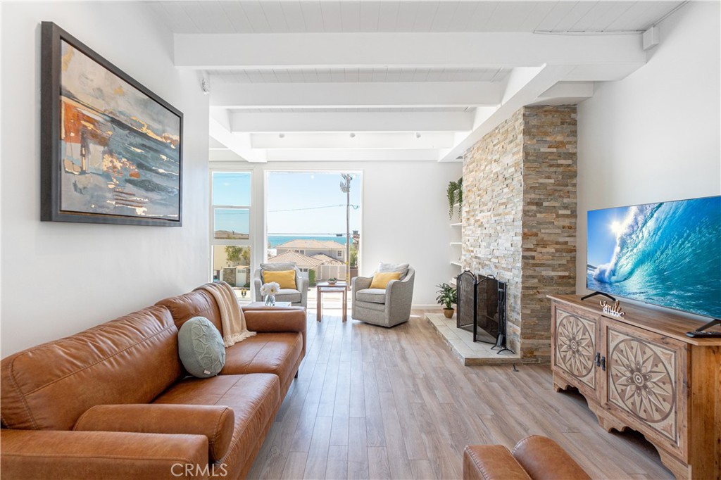 Stunning top story unit offers lovely OCEAN VIEWS from floor to ceiling west facing windows. Natural light floods the airy space, creating a warm and inviting ambiance. Recently remodeled and beautifully furnished, it's the perfect place to relax and watch the sunset. Enjoy evenings entertaining on the shared front patio of this wonderful duplex. Cross the street and you're two homes away from the ocean and long bike rides on the strand. FYI, patio, laundry and garage are shared with lower unit. 1 garage parking spot. Pet fee is $500 per pet, and exit cleaning fee is $350.