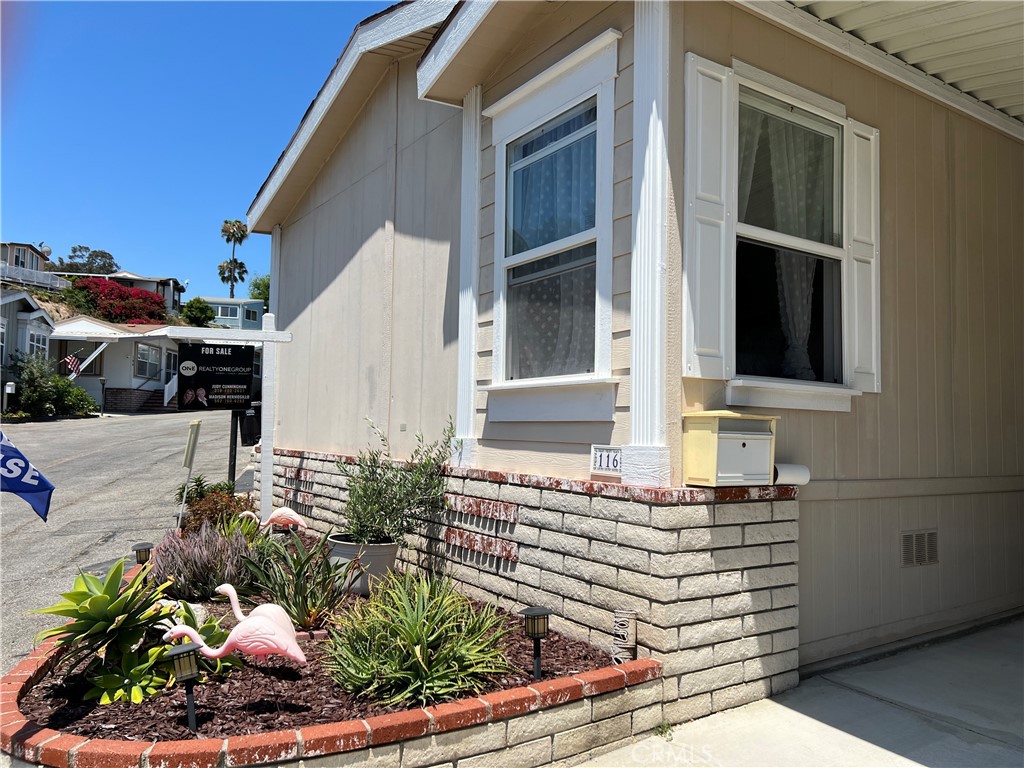 This beautiful cottage like home is located in desirable Skyline Mobile Home Park. Home was built in 2004 and includes a view of the city lights. When you enter this home you will notice all of the upgrades that have been made, such as new garbage disposal, kitchen faucet, range, dishwasher, microwave, ADA compliant toilet in master bathroom, walk in tub, lighting in the hall and laundry room, light ceiling fan in the bedroom, wall sconce in guest bedroom, exterior lights outside in the driveway, new ceiling lights and recess lights in the kitchen and living room. This home shows “Pride of Ownership” and has been well maintained. High ceilings with oak style cabinets, double pane windows throughout and a kitchen skylight allowing for a lighter and brighter in the kitchen. From the covered deck, you can relax and watch the sunset nightly. Enjoy the privacy in the back of the home which is nicely landscaped and low maintenance. Skyline Mobile home park offers many amenities such as a community room, recreation center with pool, jacuzzi, billiard room with pool tables, and putting green. Right across the street from Rolling Hills Plaza which includes Whole Foods, Trader Joe's, Bed Bath and Beyond, a bank, AMC theater, fine restaurants, and much more. This property is a must to see and conveniently minutes from the freeway and shopping.
