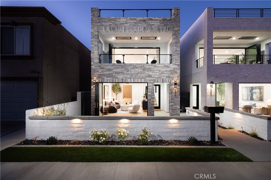 1313 Ocean Avenue is a striking blend of coastal sophistication and modern design, ideally located just steps from the sand and the vibrant boutiques and cafés of Main Street. This newly constructed 3-bedroom, 4-bathroom residence spans 2,796 square feet and showcases a reverse floor plan that elevates the main living areas to capture natural light and ocean breezes. A chef’s kitchen with Thermador appliances, a waterfall-edge island, and custom cabinetry flows seamlessly into expansive living and dining spaces, where 14-foot stacking glass doors open to a covered terrace with built-in heaters for effortless indoor-outdoor living. The primary suite offers a spa-like bath with a soaking tub, dual vanities, and a generous walk-in closet. Downstairs, a glass-and-steel staircase leads to two additional en suite bedrooms and a versatile bonus room ideal for a media space, home gym, or optional fourth bedroom. Atop the home, an 800-square-foot rooftop deck offers panoramic views stretching from the coastline to Catalina Island. Smart home wiring, solar panels, and a private elevator serving the two main floors add convenience, while the 462-square-foot garage features a 400-amp electrical system ready for EV charging, high ceilings for car lifts, and plumbing for a secondary laundry and outdoor shower. Ideally located in Seal Beach, Orange County’s northernmost coastal town, these homes offer convenient access to both Los Angeles and Orange County. Just minutes from the 405 freeway, Seal Beach is adjacent to Huntington Harbour, Seal Beach Marina, Long Beach Harbor, and Long Beach Airport. Whether you’re commuting, boating, or traveling, this location connects you seamlessly to it all - while still offering the charm, privacy, and walkability of a classic beach town.
