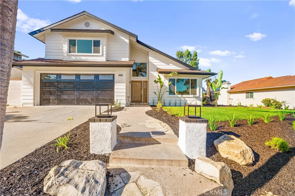 BEAUTIFULLY UPDATED! New kitchen, bathrooms, flooring and fixtures throughout. As you enter the home you are greeted by soaring cathedral ceilings and an open concept floorplan. You walk into the formal living room from the front door and can see the open concept kitchen with large island that seats 4 people. New stainless steel appliance and oak colored shaker cabinets adorn the gorgeous kitchen. The new quartz counter tops and gold faucet and fixtures further enhance the look of your new kitchen. New luxury vinyl plank flooring extends throughout the home as well. The bathrooms all feature new vanities and tiled showers. Fresh new grass expands from the front yard to the backyard and new plants and sprinkler system are included too!