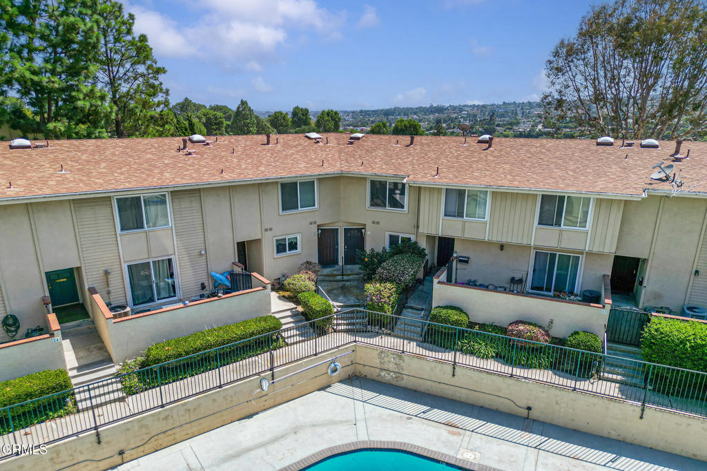 Views, views, views! This spacious Rolling Vista Town Club 2 bedroom, 2.5 bath townhouse welcomes you with views of blooming bougainvillea, lush green space and rolling hills. Offering 1,643 SF of living space, there is plenty of comfortable living space. While the home has 2 bedrooms, title records show that it is a 3-bedroom home. The next owner may want to downsize the huge primary suite to create an adjacent third bedroom. The heart of this home is the inviting living room, where two expansive dual-pane slider doors open onto a large balcony. This outdoor space provides an ideal space for morning coffee, evening relaxation or entertaining guests. The kitchen boasts newer appliances and offers a pleasant view of one of the complex's two glistening swimming pools. Upstairs, the spacious primary bedroom suite serves as a true sanctuary. Through its dual-pane windows, it mirrors the living room's expansive views, allowing you to wake up to the beauty of the surrounding landscape each day. The second bedroom features an attached full bath and is bathed in ample natural light. Additional features include a dedicated laundry room, direct-access oversized 2-car garage with a large storage area, freshly painted walls, and newly installed carpets. The appliances are included in the sale, including the GE gas stove, built-in microwave, Whirlpool refrigerator, and washer and dryer. The prime location, with its close proximity to shopping and major freeways, further enhances the appeal, offering a perfect blend of comfort, privacy, and convenience. The HOA dues include access to the pool and playground and picnic area. This is a rare opportunity to live at the Rolling Vista Town Club, a quiet community of homes, which offers a wide range of amenities, including two large swimming pools, a clubhouse and a playground.