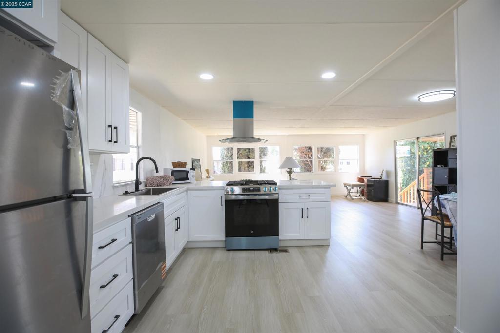 Completely renovated 2-bedroom, 2-bath home in the all-age Santiago Island Village community. This spacious and modern home features an open floor plan with brand-new luxury vinyl plank flooring, recessed lighting, and dual-pane windows throughout. The remodeled kitchen includes quartz countertops, shaker-style cabinets, stainless steel appliances, and a large center island with gas range and hood. Both bathrooms have been fully updated with modern vanities, new fixtures, and custom tile work. The primary suite offers a large closet and private en-suite bath with a walk-in shower. The second bedroom is generously sized and located near a full guest bathroom with tub and shower combo. Enjoy indoor-outdoor living with a large fenced yard, storage shed, and covered patio. Additional upgrades include fresh interior and exterior paint, new lighting, and updated systems. Conveniently located near marinas, restaurants, and outdoor recreation. Space rent required. Park approval needed for residency. Fireplaces: NO