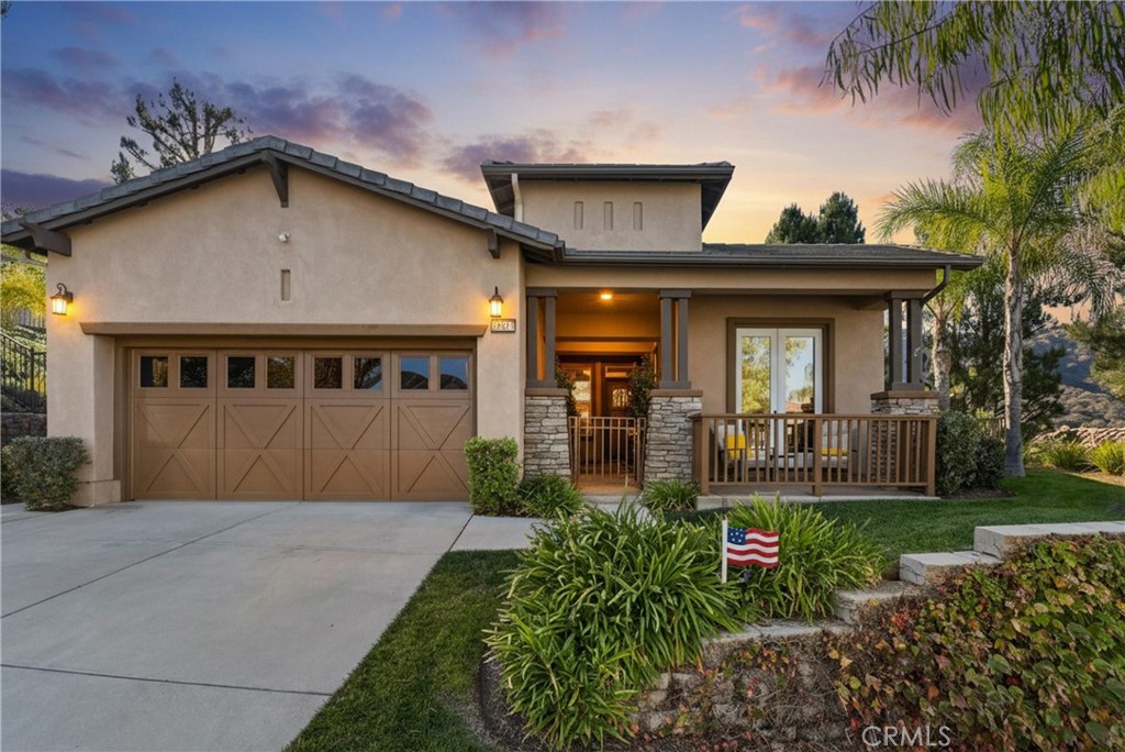 Welcome to 24217 Fawnskin, where hillside serenity meets turnkey luxury in this fully furnished Southern California gem. Backing up to open space with no rear neighbor and sweeping views, this private retreat is the perfect blend of modern comfort, designer finishes, and easy living. The charming craftsman-style exterior draws you in with its stone-accented columns, cozy covered porch, and inviting curb appeal—made even better by the HOA-maintained front yard landscaping (yes, one less thing on your to-do list). Step inside and you’re immediately greeted by a warm, open-concept layout designed to impress. Rich wood flooring flows throughout the space, anchored by a stunning stone fireplace and elevated with high ceilings, crown molding, and stylish light fixtures. The fully equipped kitchen is a chef’s dream with deep wood cabinetry, quartz countertops, stainless steel appliances, and a large island perfect for entertaining. Just off the dining area, massive windows and glass doors frame your unobstructed backyard views—and create seamless indoor-outdoor living. Out back, it gets even better. The private backyard oasis features a built-in spa with a cascading waterfall, a covered patio with ceiling fan, a mounted outdoor TV, and comfortable lounge space. All of it set against a tranquil hillside with no one looking in, just you and the sound of bubbling water under the palm trees. And here’s the best part—this home is being sold fully furnished. From the plush sectional to the chic dining setup, everything is already in place. Just bring your suitcase and settle right in. Whether you're entertaining guests or unwinding solo, this home checks every box: privacy, views, style, and convenience. Located in a sought-after community that combines scenic surroundings with low-maintenance perks, 24217 Fawnskin is more than a home—it’s your personal sanctuary.