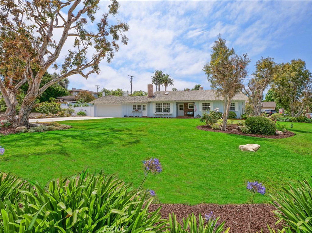 Welcome to this picture-perfect, one-level home ideally situated on a large corner lot in the coveted Lower Lunada Bay neighborhood. This truly special property is just half a block from the stunning Palos Verdes bluffs and conveniently located within blocks of the award winning Lunada Bay Elementary, Palos Verdes Intermediate and Palos Verdes High Schools, as well as the charming Lunada Bay Plaza. Bathed in natural sunlight and boasting peek-a-boo ocean views, this home captures the essence of relaxed Southern California living.
The open and functional floor plan flows seamlessly, with an inviting living room anchored by a striking Palos Verdes stone fireplace and double French doors with beveled glass that open to a covered brick patio, making indoor-outdoor living and entertaining a breeze. The spacious kitchen has a sunny dining area overlooking the backyard and opens to the cozy family room complete with fireplace and vaulted ceilings. The adjacent bonus room also has vaulted ceilings and offers direct access to the front and back yards as well as the garage. Just imagine the possibilities for this room - it makes a wonderful home office, playroom, studio or even a formal dining room!
The spacious primary bedroom features an en-suite bathroom, while two additional generously proportioned bedrooms offer ample closet space and comfort. The expansive, private backyard is graced with delicious fruit bearing avocado, fig, apricot, lemon and grapefruit trees and provides an ideal setting for relaxing, gardening, or outdoor gatherings. The huge front yard includes lush landscaping and fruit bearing apple, peach, plum and apricot trees.
This one of a kind sun-filled coastal gem offers the perfect blend of charm, comfort, and location. Come experience your slice of paradise in Lunada Bay!