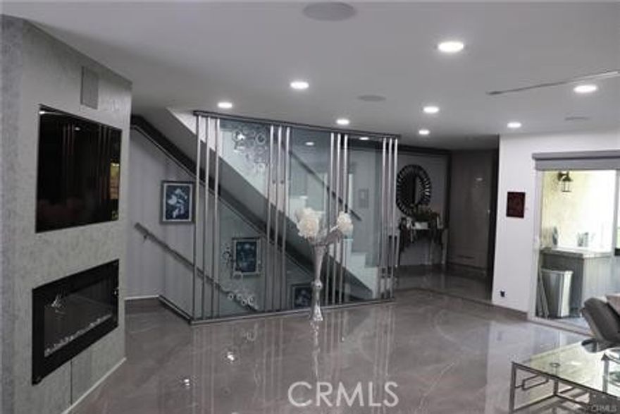 In the heart of Cabrini Villas sits this 3 bedroom/2.5 bathroom glossy modern home and honestly, what doesn't it offer? From extra storage convenience to top of the line modern technological features such as Nest Ac with vents in the ceilings, with central AC running all the way down to the garage gym/office, to surround system speakers and recessed lights built right into the living room ceiling, a flat screen TV and gorgeous fireplace build into the wall staring across a modern build spacious living room with grey marble flooring that spans all the way to the dinning room and new-top-of-the-line kitchen cabinets and equipment. The listing will include the matching set refrigerator, built in Tv, washer/dryer unit in garage, and much more. As you enter the house into a beautiful foyer, you will see a newly built staircase right in front, each step with built in lights underneath and a solar powered skylight up above which casts natural light during the day and electrical lighting during night time. The upstairs holds a master-bedroom which comes with a walk in closet/office space and master bathroom. With 2 other spacious bedrooms with their own closets and a shared bathroom. The first floor garage level also holds an extra spacious room which can be used as an office or game room for the kids! The garage has also been fully remodeled with lots of cabinets and storage space and has a very clean/tidy feel to it. The washer/dryer and electric water heater are in the garage storage hidden. Garage door can be opened remotely via iPhone and house comes with security cameras for extra safety. Cold water, cable TV and Internet access are included in the rent price! The home also comes with a private patio on the main floor which holds space for a full seating set and a grill, to enjoy outdoors life! Cabrini villas itself offers a multitude of pools, tennis courts, parks, and a safe environment to live in.