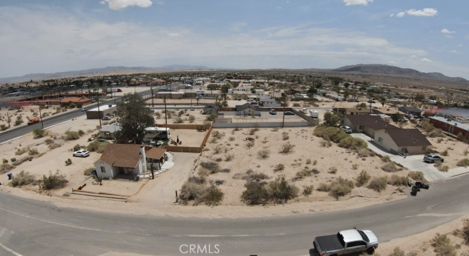 Prime Downtown 29 Palms Lot with Utilities – Affordable Desert Investment This 0.18-acre parcel sits in the heart of downtown 29 Palms, offering water and power in the street and unmatched accessibility to all local amenities—shops, restaurants, schools, and the iconic entrance to Joshua Tree National Park just minutes away. Whether you’re ready to build now or simply hold as a long-term investment, this property is perfectly positioned in one of the fastest-growing desert markets. Opportunities like this are rare at such an affordable price point. An added bonus: the adjacent parcel is also available, allowing you to double your lot size and expand your vision. All lot lines shown in photos are approximate. Buyer to verify all utilities and property details during due diligence. Fictitious address to help locate property more accurately.