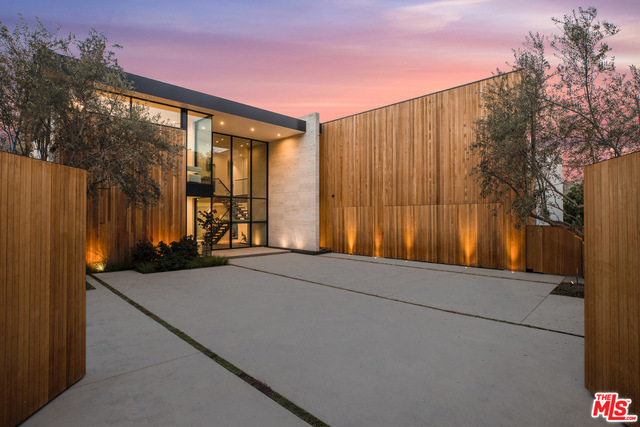 Perfectly private new Contemporary retreat off Bel Air Road viewing beautiful peaceful scene of harmonious nature with exquisite architecture. Tall gates allow entry into large Motorcourt and the impressive 2-story glass entry welcomes you into a rare, spacious environment. 3 minutes above Sunset Blvd and like no other escape in LA, the house rises like sculpture with stone, glass & wood exterior. Main entertaining/ lounging spaces are large and open to each other endlessly - all rooms seeing unbelievable views outdoors and the unforgettable wraparound zero-edge Pool. Organic Kitchen provides ultimate Miele appliances & SubZero and nearby walk-in display Wine Rm. Huge Master Suite presents a Spa Bath, Refreshment bar, outdoor Lounge plus walk-in Dressing Rm. All bedrooms are suites. Interior destinations include a wood-clad Library, enormous Theater/Media/ Activities room, an Art Gallery plus 3-car enclosed Garage w/direct entry. There is nothing finer at this elevated lifestyle level.