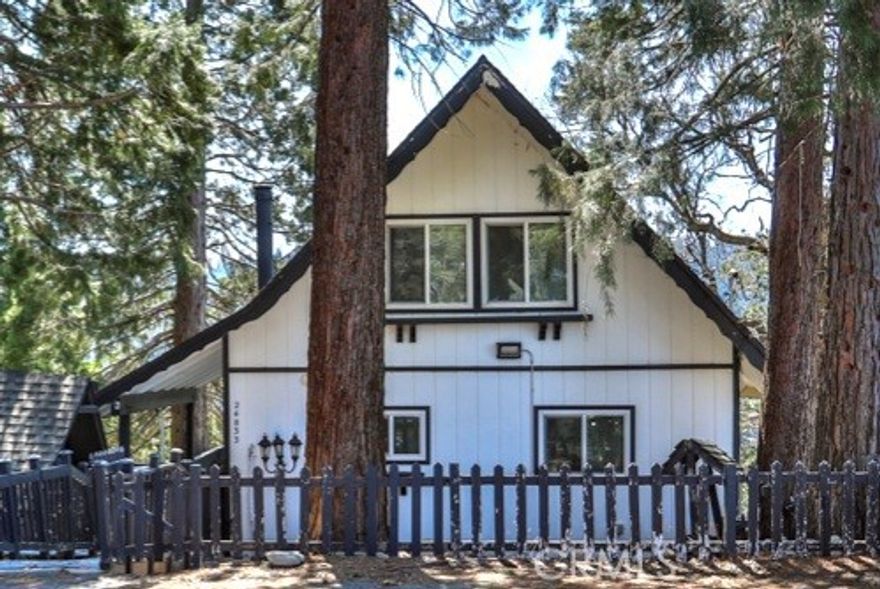 Escape to the serene, alpine beauty of Crestline with this charming A-frame cabin that blends classic architecture and modern comforts. Nestled less than a mile from the picturesque Lake Gregory, adventure awaits with hiking trails like Crestline Canyon, Heart Rock, and Strawberry Peak nearby. Step inside to the soul-inspiring living room with soaring, two-story vaulted ceilings adorned with natural wood and open beams, creating a warm and inviting ambiance. Awash in natural light from two-story windows framing stunning mountain views, the living room offers a perfect retreat to unwind and make memories. Enjoy cooking up a great meal in the upgraded kitchen, featuring granite counters, custom tile backsplash, and pendant lights over the breakfast bar. Central heating, ceiling fans in each bedroom, and dual-pane windows ensure year-round comfort, while the cozy fireplace beckons for relaxing evenings. Fully remodeled with laminate flooring and custom lighting throughout, this retreat is move-in ready. The upstairs loft offers a second, cozier living space with a beautiful view and a cathedral-ceilinged bedroom. Downstairs, you’ll find three additional bedrooms, a fully remodeled bathroom, and the washer and dryer. One of the bedrooms does have a closet and is currently used as a game/storage room. Relish in evergreen, mountain vistas from the wraparound deck, perfect for stargazing or savoring your morning coffee. With Lake Gregory less than a mile away, enjoy fishing, boating, or a leisurely stroll along the scenic trail. Crestline's shops and restaurants are less than two miles away. Looking for a turnkey combination investment and vacation home? This one is already registered for short-term rental (Airbnb/VRBO). The designer furnishings are available for separate purchase, allowing you to effortlessly get started. On top of all that, the electrical panel has been upgraded to 200 amps with load-balancing, and the water heater is new. Don't miss the chance to make memories in this mountain oasis, tucked within the tranquil surroundings of San Bernardino National Forest. Be sure to check out the video and 3D tour, and welcome home!