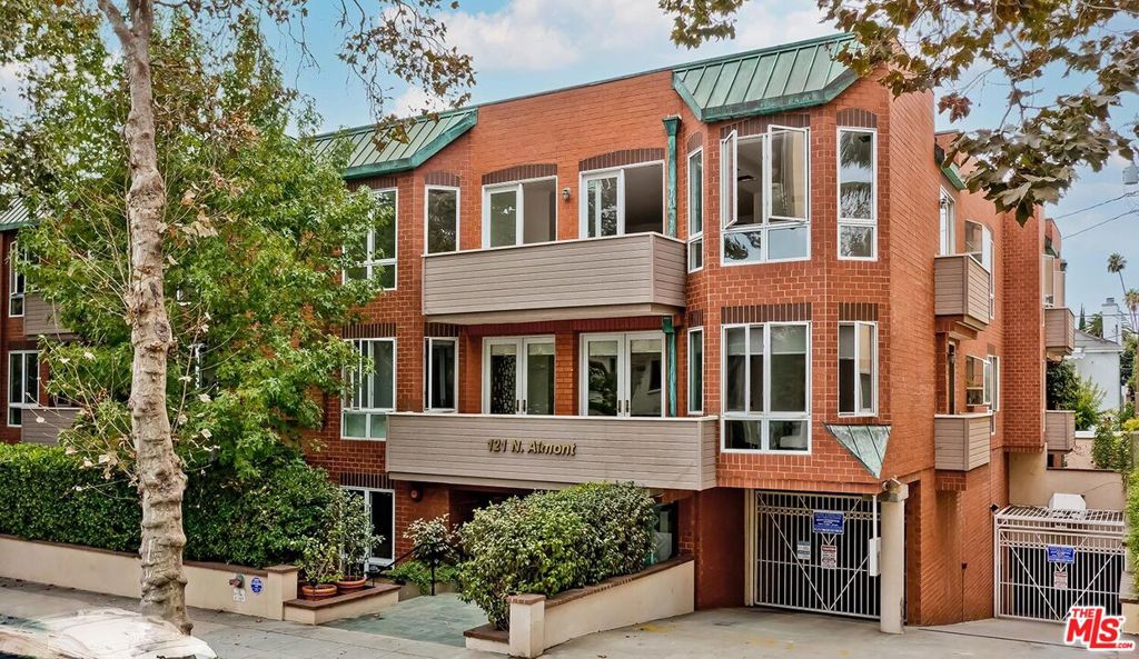 Sunlit, spacious, and immaculate coveted southeast front corner penthouse unit featuring lovely treetop vistas, high ceilings, an open entertainment plan, and gorgeous light herringbone wood floors throughout (no carpets). Rotunda-style marble entry leads to the large living room with fireplace and wet bar which opens to a private balcony with bucolic treetop streetfront views. Gracious dining room overlooking Almont as well. Fabulous chef's kitchen with stainless appliances and laundry. Front-facing primary suite with walk-in and luxe bath. Huge secondary bedroom suite. Exclusive 14-unit low-rise security building with gym, meeting room, big rooftop view patio, side x side gated subterranean parking, guest parking, EQ insurance. A great top floor space in the perfect location on a quiet road moments from the best of Beverly Hills and the Westside.