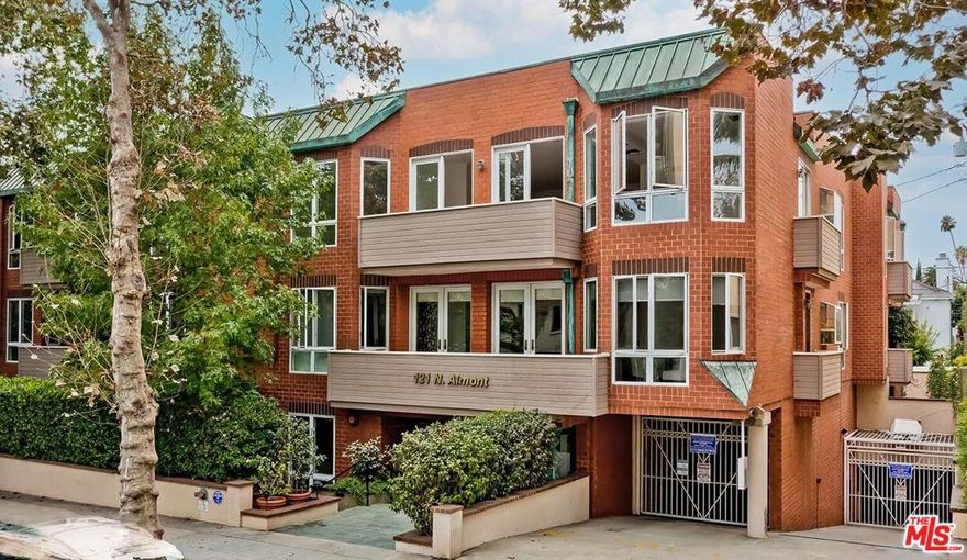 Sunlit, spacious, and immaculate coveted southeast front corner penthouse unit featuring lovely treetop vistas, high ceilings, an open entertainment plan, and gorgeous light herringbone wood floors throughout (no carpets). Rotunda-style marble entry leads to the large living room with fireplace and wet bar which opens to a private balcony with bucolic treetop streetfront views. Gracious dining room overlooking Almont as well. Fabulous chef's kitchen with stainless appliances and laundry. Front-facing primary suite with walk-in and luxe bath. Huge secondary bedroom suite. Exclusive 14-unit low-rise security building with gym, meeting room, big rooftop view patio, side x side gated subterranean parking, guest parking, EQ insurance. A great top floor space in the perfect location on a quiet road moments from the best of Beverly Hills and the Westside.