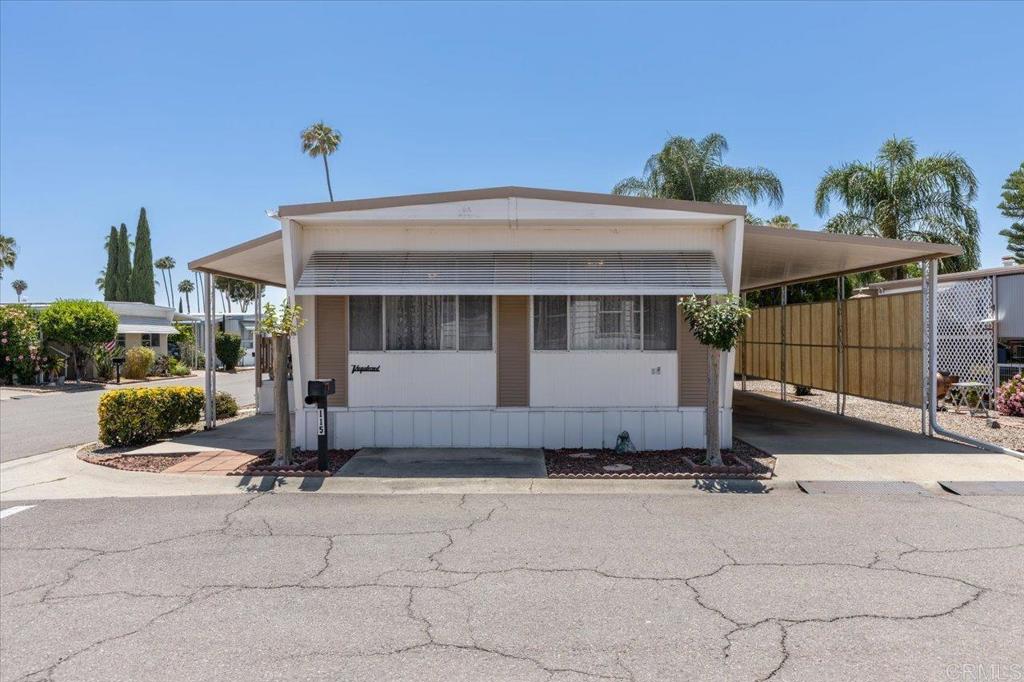 Cute home located on a corner lot in Imperial Mobile Estates; a clean, well kept 55+ community with rent control. This home features Kitchen updates, a newer furnace & toilets, & some upgraded dual pane windows. The Primary Bedroom has two closets. Low maintenance yard with two citrus trees (Orange & tangerine). Spacious storage shed and parking for up to 3 vehicles in the carport. Home is conveniently located near one of two community pools. This beautiful 55+ park offers many social activities & amenities, 2 pools (one heated year around), spas, rec room, clubhouse, billiards, exercise room, game room and quiet rooms to enjoy meetings. RV parking available for a small additional fee. There is a bus stop at the entrance to the park for convenient transporation. Grocery stores, restaurants, and banks are all within walking distance.