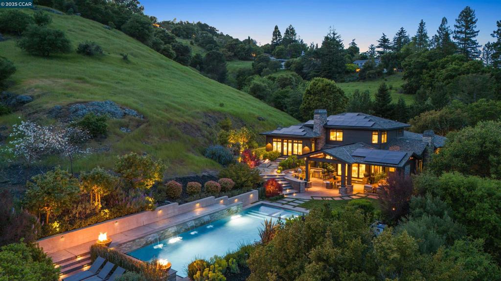 Welcome to 38 Valley View Drive, a luxurious, eco-conscious retreat nestled on a private, gated estate in the hills of Orinda. Completed in 2017 by GreenPoint Homes and designed by Steve Kubitschek, this exceptional home combines elegant design, high-end finishes, and sustainable living. Just minutes from top-rated schools, town, and BART, it offers a perfect balance of seclusion and convenience. The open floor plan features 10’ ceilings, White Oak hardwoods, reclaimed wood accents, Andersen windows, and custom cabinetry. The chef’s kitchen boasts SubZero and Thermador appliances, quartz countertops, and flush inset cabinetry. An accordion door opens to a spectacular outdoor living space with a pavilion, pizza oven, pool, hot tub, and sport court. The primary suite offers a spa-like bath, heated floors, and dual walk-in closets. Additional highlights include a media room, executive office, wine cellar, mudroom, two laundry rooms, and a 3-car garage. With 44 solar panels, Tesla Powerwalls, EV charger, whole-home audio and security, 38 Valley View delivers refined, energy-efficient indoor/outdoor living at its finest! Welcome home! For more details,visit https://www.38ValleyViewDrive.com