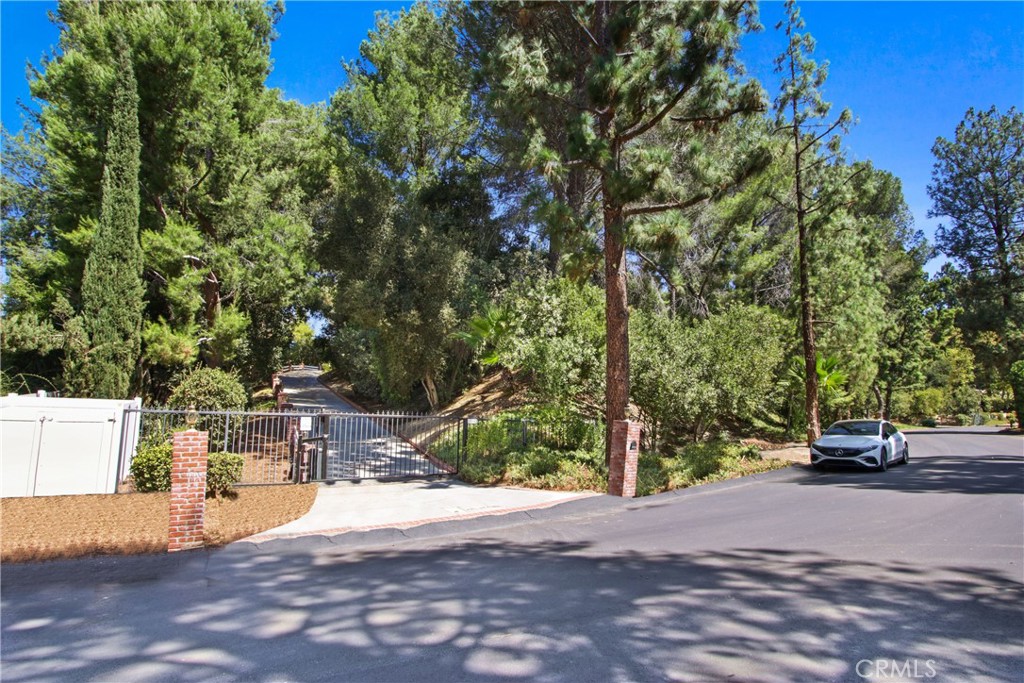 Craving tranquility, seclusion, and picturesque hillside views? This beautiful 5-bedroom, 3-bath single-level home in Canyon Country delivers nearly 3,000 sq ft of effortless California style on just under an acre of tree-draped land!
Set in scenic Sand Canyon, its inviting interior displays engineered hardwood floors, ample natural light, and a soothing neutral palette to create a warm, open flow throughout. The living area draws you in with a modern fireplace flanked by illuminated windows, while the adjacent dining corner glows beneath a stunning wheel chandelier. New air condition unit installed. The chef-inspired kitchen is striking, with a pot filler, subway tile backsplash, stainless steel appliances, oversized island, and abundant cabinetry. French doors lead you outside to a pergola-covered patio and lush lawn, ideal for relaxed evenings or weekend BBQs.
A connected ADU with its own kitchen and a secret entry provides flexibility and fun. Notables include an extra-long driveway, an attached 2-car garage with built-ins, a butler’s pantry/laundry combo, and another detached two car garage. Come experience all it has to offer and take the next step toward the lifestyle you’ve always imagined!