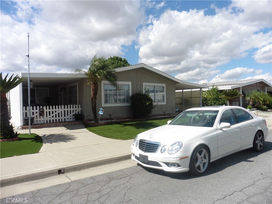 CONTINGENT ON SELLER FINDING A SUITABLE REPLACEMENT HOME. Say NO to paying space rent and you own the LAND in the Sierra Dawn North 55+ Senior Living. This single story manufacture home is on a permanent foundation and qualifies for all types of financing. Almost impossible to find a property in this community that also has a covered carport and attached garage with direct access. You will not struggle finding a place to park and their is Ample amount of space to park multiple vehicles in the garage, carport or the driveway. Low maintenance and water saving landscaping that will help save you money. White picket vinyl fencing, and large covered porch area. Oversize family room that has plenty of space for bigger size furniture, separate dining area with ceiling fan, Kitchen with lots of cabinets, pantry, formica counters that is adjacent to the enclosed patio that could be used as a craft room. This two bedroom, two full bathroom with it's own laundry room that has additional cabinets and a sink gives you approximately 1464 of living area. Affordable extremely low YEARLY HOA of $40. Close proximity to Target, Home Depot, grocery stores, and restaurants. Act now and don't miss out on affordable living in Southern California. CONTINGENT ON SELLER FINDING A SUITABLE REPLACEMENT HOME.
