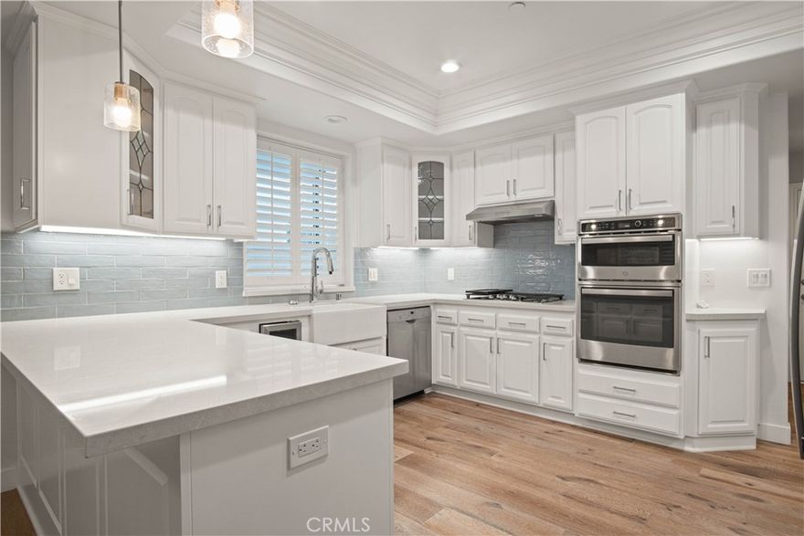 This detached townhome enchants from the moment you step inside. French oak wood floors lead you to a spacious living room with a cozy fireplace—perfect for leisurely mornings or movie nights with loved ones. Double glass doors open to an intimate rear yard, featuring stunning stonework ideal for outdoor dining or quiet relaxation. Just around the corner, the remodeled kitchen dazzles with timeless finishes, sleek new countertops, a large pantry, a charming garden window, and a welcoming breakfast bar—the true heart of the home. Upstairs, convenience and comfort await with a thoughtfully placed laundry area, two bright bedrooms, and a beautifully updated hall bath. The primary suite feels like a personal retreat, boasting soaring ceilings, a romantic Juliette balcony, and a double-sided fireplace that warms both the bedroom and the spa-like ensuite, complete with a luxurious Jacuzzi tub. And the walk-in closet? The largest we’ve ever seen—an absolute dream! Bathed in natural light from skylights and adorned with fresh, airy details, this thoughtfully designed home blends charm and elegance, creating a bright and inviting space to make lasting memories.