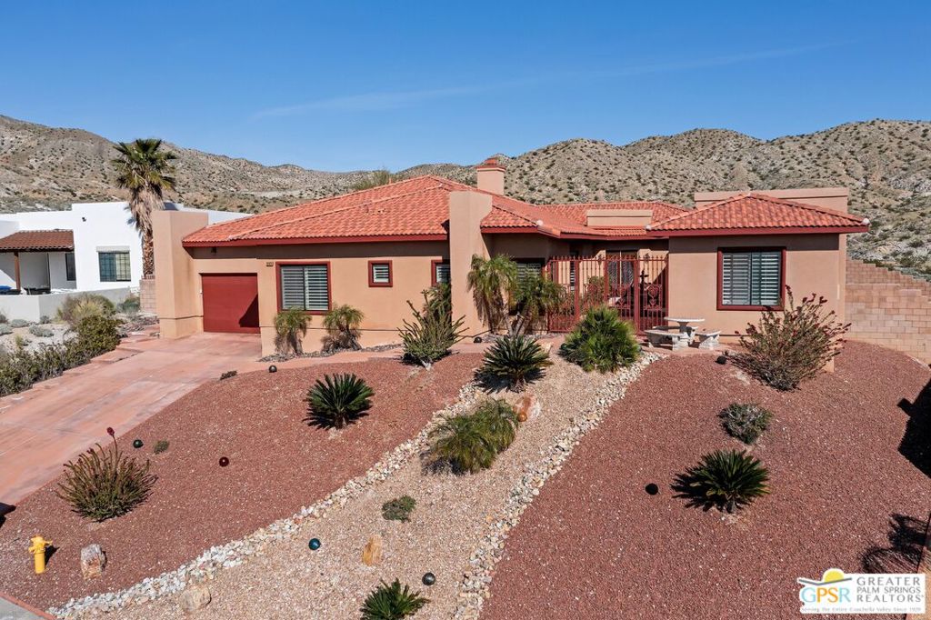 Welcome to this exceptional desert retreat offering a perfect blend of luxury and comfort. Spanning 3100 square feet with an additional 300 square feet detached casita, this meticulously crafted home features high-quality construction and breathtaking views of the desert valley. The spacious kitchen is a chef's dream, perfect for culinary enthusiasts. The living area boasts a cozy fireplace and bar. The spectacular primary suite is complete with a spa-like ensuite bathroom including a jetted tub and two walk-in closets. All bedrooms are ensuite with their own bathrooms. Outside, the expansive backyard offers a private sanctuary with views, perfect for entertaining or unwinding in tranquility. The backyard is large enough to build a pool and spa. The detached casita provides additional space for guests or can be used as a private office or studio. Located in a prime location, this home offers a serene desert living experience while being just a short drive away from the vibrant city life of Palm Springs. Don't miss out on this opportunity to own a truly remarkable property!