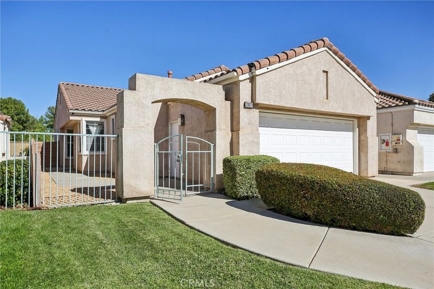 Move-in ready 2 bed, 2 bath home located within the highly desirable Andalusia community at Menifee Lakes is ready for its new owner! NOT A 55+ COMMUNITY. Conveniently located 3 doors away from the community pool and spa as well as exclusive access to the Lakes! This turn-key home features great curb appeal with well manicured landscaping, and the interior is open and spacious with vaulted ceilings, carpet, and tile flooring, and neutral paint scheme. The living room features skylights, a cozy fireplace, and flows into the formal dining room which sits just off of the kitchen with wood cabinetry offering lots of storage space, tile countertops, and an in-kitchen breakfast nook area. Both bedrooms are generously sized with the large primary suite featuring a private ensuite with dual sink vanity and a walk-in shower. There is also a hall bathroom for the second bedroom and guests to share, as well as a laundry room with additional storage space and direct garage access. Enjoy the low maintenance backyard with full fencing, concrete and rocks - this is the perfect space for a patio set and to entertain guests! Residents also get to enjoy an assortment of amenities including a sparkling pool and spa, playground, trails, tennis courts, basketball courts, and exclusive access to Menifee Lakes! Also conveniently locate near the new Menifee Library, Wheatfield Park, as well as schools, shopping, dining, and more! Schedule your private tour today!
