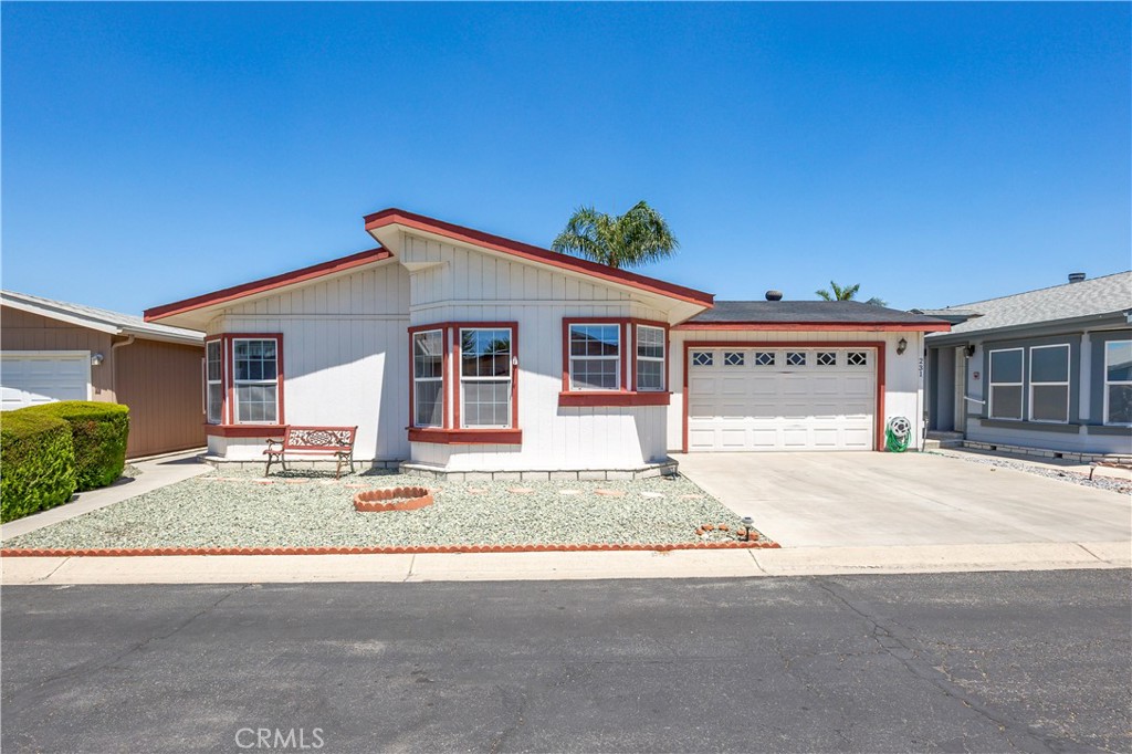 1250 N Kirby St #231, Hemet, CA – Spacious & Upgraded Home with Rare 2-Car Garage in the Foothills of Hemet 55+ Community. Welcome to this beautifully maintained 2-bedroom, 2-bathroom home located in the highly desirable Foothills of Hemet, a gated 55+ community known for its peaceful setting and resort-style amenities. This spacious home stands out with tall ceilings, an open floorplan, and upgrades throughout. The large kitchen is a standout feature, offering a center island, abundant cabinetry, and a seamless flow into the formal dining room—perfect for entertaining. The oversized living area provides ample room to relax and enjoy the natural light that fills the space. The primary bedroom suite includes a bonus area ideal for a home office, craft space, or reading nook, along with a private bath and generous closet. The secondary bedroom and full guest bath are equally well-sized, and there's a convenient indoor laundry room for added functionality. A rare find in this community: this home boasts a full 2-car garage, available only in select homes in the back section of the park. This is an incredible bonus, especially on a land-leased lot, where garages of this size are uncommon. Enjoy the outdoors from the covered front porch or unwind in the low-maintenance yard. A private storage shed is also included. All this with a low monthly space rent of just $875! Residents of the Foothills of Hemet enjoy access to a pool, spa, clubhouse, fitness center, billiards, and a vibrant calendar of social activities. Conveniently located near shopping, restaurants, medical centers, and more. Don’t miss the opportunity to own this rare gem with exceptional features in one of Hemet’s most popular senior communities!