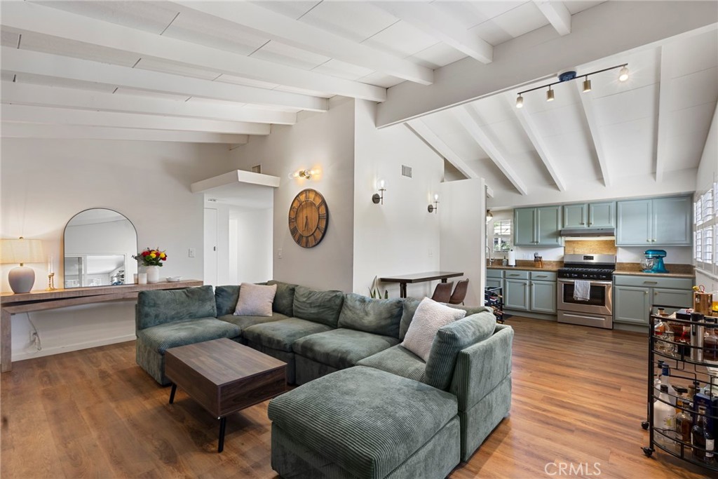 Welcome to your La Mirada dream home — where modern upgrades meet timeless charm! This beautifully updated 3-bedroom, 2-bathroom residence spans 1,410 sq. ft. of living space and sits on a spacious 6,858 sq. ft. lot, offering the perfect blend of comfort, style, and convenience, with shopping, dining, and major highways just minutes away. Inside, you’ll be welcomed by soaring A-frame ceilings with exposed beams and luxury vinyl plank flooring throughout. The spacious living room centers around a cozy fireplace and opens seamlessly into the dining area and renovated kitchen, featuring sleek granite countertops, stainless steel appliances, and modern finishes — perfect for everyday living and entertaining. Down the hall, three well-sized bedrooms and two updated bathrooms strike the perfect balance of style and functionality, making this move-in ready property a true La Mirada gem.
Step outside to enjoy a newly landscaped backyard designed with entertaining in mind. A large paved patio offers plenty of room for dining and lounging, while the expansive wooden pergola with a built-in bar and seating area creates the ultimate gathering space. Mature greenery surrounds the yard, adding privacy and charm, while the open layout is ideal for barbecues, celebrations, and relaxing evenings under the California sun.