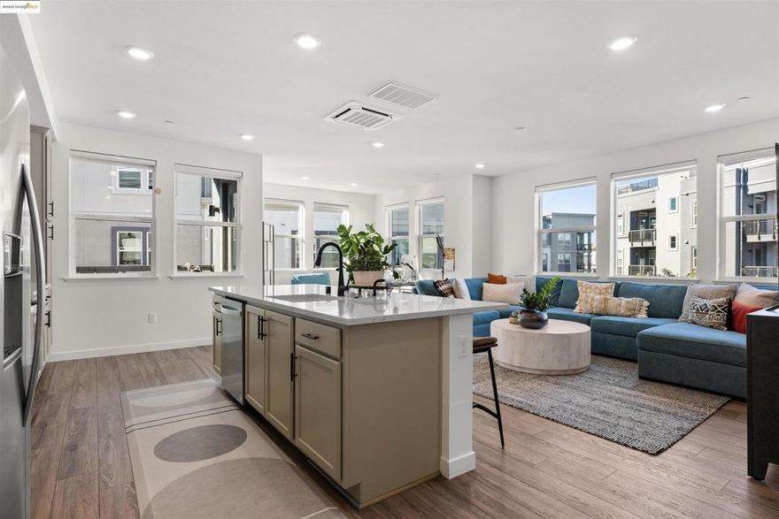 Welcome to this stunning, nearly new, contemporary corner condo in Alameda’s Bay 37 waterfront community, completed in 2023. This two-bedroom, two-bath home features a roomy, open-concept layout, perfect for modern living. The heart of the home is a shining kitchen with a central island, flowing seamlessly into the living room, which is bathed in natural light from sweeping windows. Enjoy a captivating "peek-a-boo" view of Oakland’s Inner Harbor and the distant top of City Hall while dining. For truly panoramic vistas, including the Bay Bridge and downtown San Francisco, residents can enjoy the shared rooftop deck. The home includes many modern conveniences: in-unit laundry, a dedicated garage with EV charging capabilities, and an owned solar system. Bay 37 offers residents an array of amenities, including waterfront walking paths, picnic areas, a park and playground, and a community dock. Commuting is effortless with a complimentary water taxi service to Jack London Square and a free shuttle to 12th St. Bart Station, providing easy access to SF via ferry or Bart. Plus, neighborhood essentials like Target and Safeway, along with diverse dining options, are all within a half-mile radius!