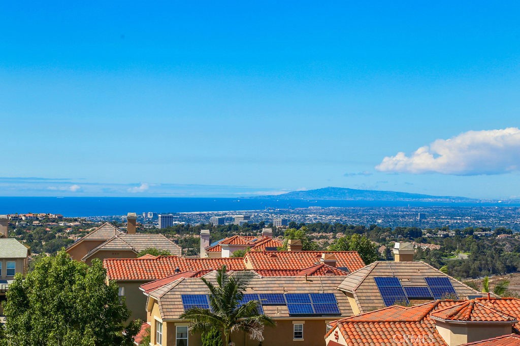 Experience elevated coastal living in this beautifully appointed 4-bedroom, 2.5-bathroom residence, ideally situated behind the gates of Newport Coast’s coveted Campobello community. Enjoy sweeping ocean views from most rooms in the home, where abundant natural light pours through expansive windows, creating a bright and serene ambiance throughout.
The elegant main level features luxurious travertine flooring and an open-concept layout designed with entertaining in mind. The gourmet kitchen boasts rich granite countertops, a central island with a built-in cooktop, and a layout that seamlessly connects to the family room — allowing for ocean-view cooking and effortless hosting. A conveniently located half bath and spacious laundry room with utility sink and outdoor access enhance everyday functionality.
Upstairs, the expansive primary suite is a true sanctuary, highlighted by panoramic ocean vistas from both the bedroom and spa-inspired ensuite bath. Indulge in a soaking tub with breathtaking views, a walk-in shower, dual vanities, a private water closet, and a generous walk-in closet complete with built-ins. Three additional bedrooms offer flexible living space, including a large upper-level room with a cozy fireplace — perfect as a fourth bedroom, home office, or media lounge.
The oversized three-car garage features epoxy flooring and ample storage. Residents of Campobello enjoy access to resort-style amenities, including a sparkling community pool, spa, and tennis courts. All just moments from world-class shopping and dining at Fashion Island and Newport Coast Shopping Center, with pristine beaches and scenic coastal trails just minutes away.