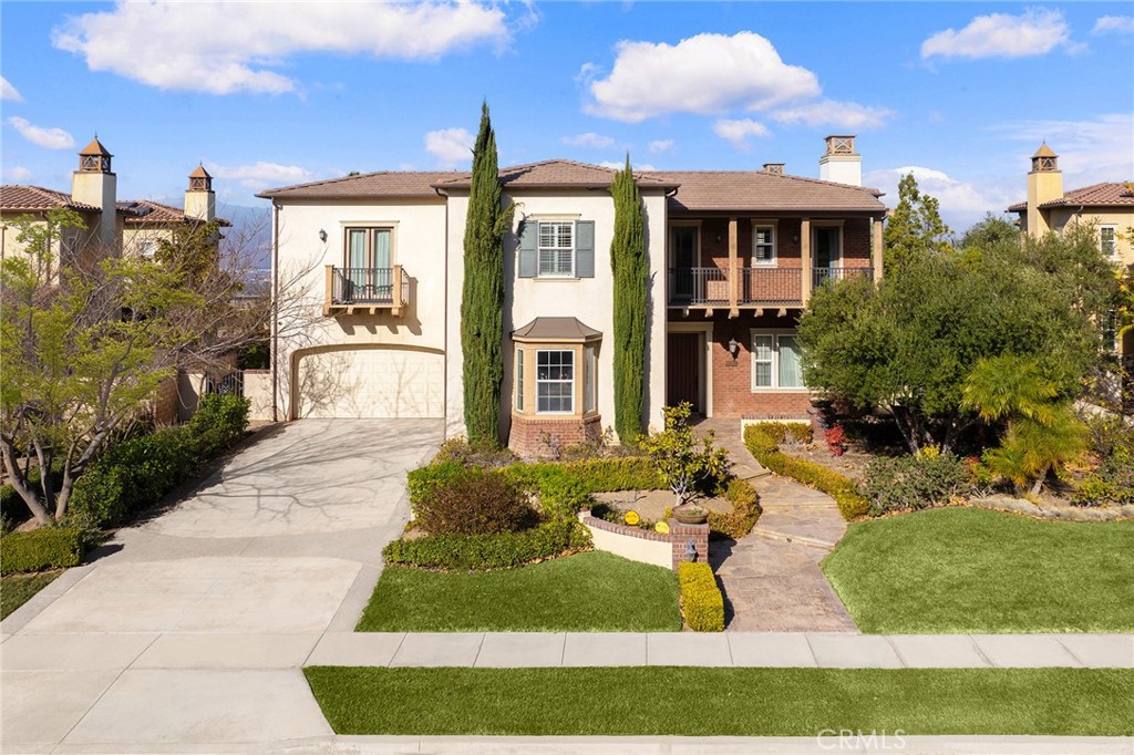 Welcome to 19599 Highland Terrace Dr, a remarkable Italian-style residence located in Walnut’s prestigious Three Oaks community. Perched on a 17,789 square foot flat Cul-De-Sac lot with breathtaking 180-degree panoramic city lights and snow-capped mountain views, this stunning home boasts 4,818 square feet of luxurious living space.
Upon entry, a soaring two-story foyer opens to an office on the first floor, a formal dining room, and a spacious family room with a cozy fireplace. The gourmet kitchen is a chef’s dream, equipped with premium stainless-steel KitchenAid appliances—including a 42" built-in refrigerator, an 8-burner stove, and a double oven—along with a Butler’s pantry and a sizable walk-in pantry. A convenient breakfast nook, powder room, and laundry room next to the garage complete the main level.
This home features five en suite bedrooms, including a primary suite with a comfortable retreat area, ideal for relaxation. Upstairs, you’ll also find a huge loft adjacent to the primary bedroom, offering additional living or entertainment space. Throughout the home, elegant details abound: multiple single and double French doors, crown molding, plantation shutters, recessed lights, decorative glass windows, upgraded carpeting, hardwood flooring, and a purified drinking water system. The gourmet kitchen and bathrooms showcase Colonial Golden Roma Granite countertops with custom ceramic and quartz tile backsplash for an exquisite finishing touch.
Outside, the professionally landscaped backyard invites you to enjoy a tranquil koi fish pond with a cascading fountain, as well as a viewing platform that captures the stunning vistas viewing, and your very own private basketball court for leisurely recreation. Meticulously maintained and in excellent condition, this extraordinary property offers the finest in Walnut living. Don’t miss the chance to make this dream home yours!