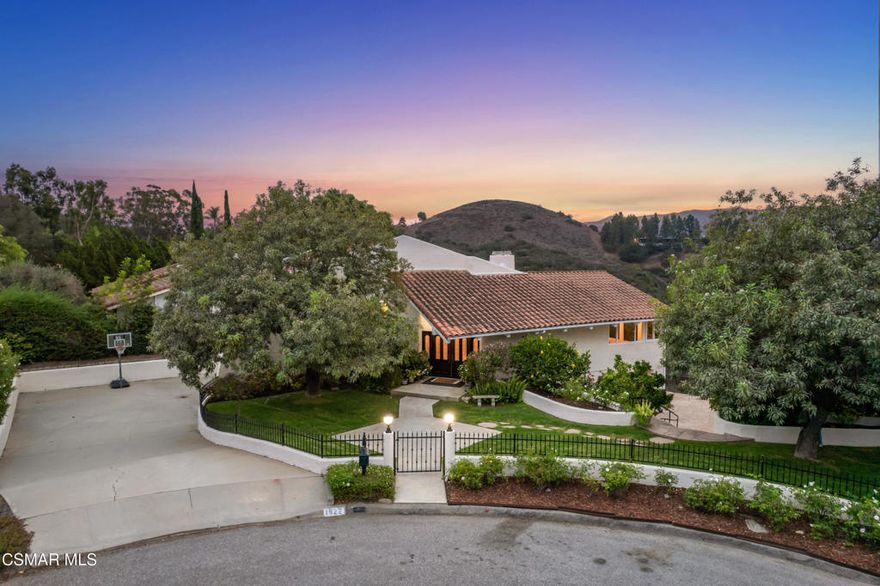 Ultimate Thousand Oaks View Estate ideally located at the end of a serene cul-de-sac in the heart of the Conejo Valley. This extraordinary Mediterranean retreat offers panoramic views of the Barranca and the Santa Monica Mountains, and it's surrounded by the scenic hiking trails of Wildwood. This approximately 4,000 sq. ft. estate features 4 bedrooms plus an office and 3 1/2 bathrooms. Step inside and be immediately greeted by vaulted beamed ceilings and walls of windows that frame dramatic views from nearly every room. The spacious living area is highlighted by a striking floor-to-ceiling rock fireplace, creating a warm focal point for gathering. The open concept floor plan flows seamlessly into the dining and entertaining spaces, with natural light pouring in from every angle.  On the lower level there's a massive bonus/game room with its own breathtaking views, a perfect entertainment hub. The outdoor living has expansive jet lined views with patios, fire pit, professional landscaping, and a private putting green, all designed to maximize the home's hillside setting. This is a very special offering, a rare opportunity to own one of the most view-centric homes in Thousand Oaks, blending privacy, space, and unmatched access to nature in a way that is seldom available.