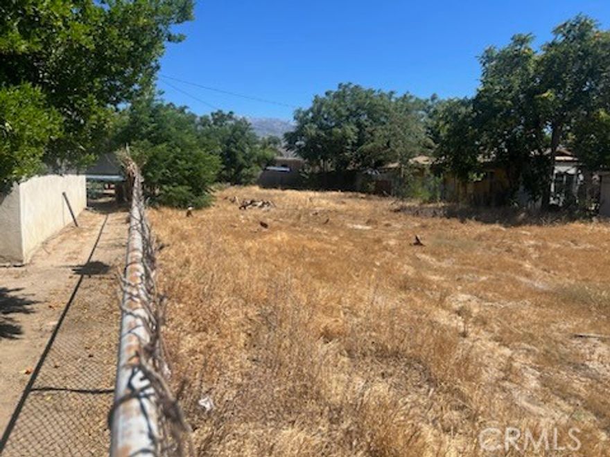 Property located near post office, stores, courthouse and police station in friendly growing community. Buildable land terrain 

 with existing residences on either side of subject property.