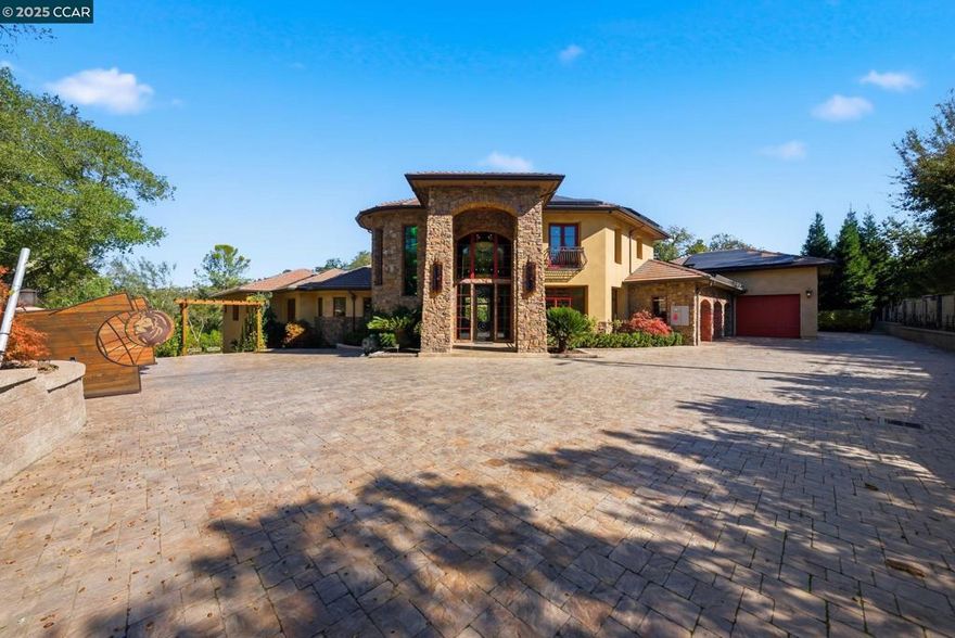 Stunning custom-built estate in one of Danville’s most exclusive country settings in the El Pintado area. This 2022 residence offers 7,470 sq. ft. of refined living on over an acre, featuring 5 bedrooms, 6 baths, 3 stories and multiple living spaces for entertaining or everyday comfort. The gourmet kitchen boasts top-of-the-line appliances, custom cabinetry, and a butler’s kitchen. The luxurious primary suite includes a spa-inspired bath, private terrace, and a hidden door in the walk-in closet leading to a private entertainment room. Exceptional craftsmanship, multiple fireplaces, and a 4-car garage add to the appeal. The expansive backyard offers great potential with a pool project that was started but not completed (renderings available) and includes a beautiful private vineyard producing grapes to make your own wine—perfect for enjoying your own slice of wine-country living. Conveniently located near downtown Danville, top-rated schools, and amenities.