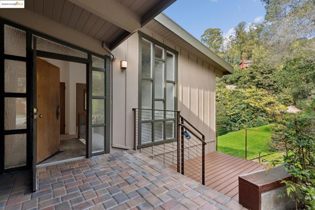 Snazzy mid-century with vaulted ceilings, open floor plan and loads of light. Spacious living-dining area with fireplace and ideal walls for big art. Updated kitchen with adjacent laundry/pantry. One step to entry! Primary suite on main level overlooks greenbelt. Downstairs is a family room with deck that leads to terraced gardening beds. Two bedrooms and an office nook are on this level, with access to a large back deck and hot tub. Ample storage throughout. Lovingly maintained by current owners for nearly 40 years.